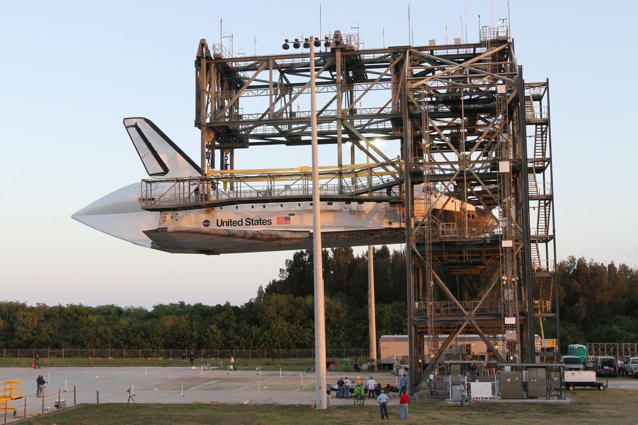CAPE CANAVERAL, Fla. – At the Shuttle Landing Facility at NASA’s Kennedy Space Center in Florida, space shuttle Discovery slowly is lifted to the 60-foot level inside the mate-demate device in preparation for the arrival of the Shuttle Carrier Aircraft.    The device, known as the MDD, is a large gantry-like steel structure used to hoist a shuttle off the ground and position it onto the back of the aircraft, or SCA. This SCA, designated NASA 905, is a Boeing 747 jet originally manufactured for commercial use, which was modified by NASA to transport the shuttles between destinations on Earth. NASA 905 is assigned to the remaining ferry missions, delivering the shuttles to their permanent public display sites. Discovery’s new home will be the Smithsonian's National Air and Space Museum Steven F. Udvar-Hazy Center in Chantilly, Va. For more information on the SCA, visit http://www.nasa.gov/centers/dryden/news/FactSheets/FS-013-DFRC.html. For more information on shuttle transition and retirement activities, visit http://www.nasa.gov/transition. Photo credit: NASA/Kim Shiflett