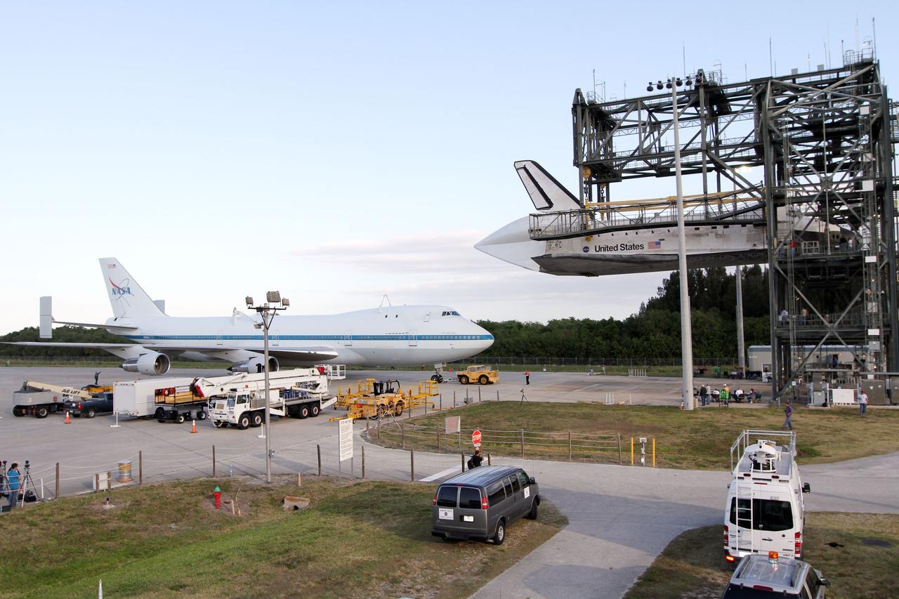 CAPE CANAVERAL, Fla. – At the Shuttle Landing Facility at NASA’s Kennedy Space Center in Florida, the Shuttle Carrier Aircraft moves into position under space shuttle Discovery suspended 60 feet off the ground in the mate-demate device.     The device, known as the MDD, is a large gantry-like steel structure used to hoist a shuttle off the ground and position it onto the back of the aircraft, or SCA. The SCA is a Boeing 747 jet, originally manufactured for commercial use, which was modified by NASA to transport the shuttles between destinations on Earth. The SCA designated NASA 905 is assigned to the remaining ferry missions, delivering the shuttles to their permanent public display sites.  NASA 905 is scheduled to ferry Discovery to the Washington Dulles International Airport in Virginia on April 17, after which the shuttle will be placed on display in the Smithsonian's National Air and Space Museum Steven F. Udvar-Hazy Center. For more information on the SCA, visit http://www.nasa.gov/centers/dryden/news/FactSheets/FS-013-DFRC.html. For more information on shuttle transition and retirement activities, visit http://www.nasa.gov/transition. Photo credit: NASA/Kim Shiflett