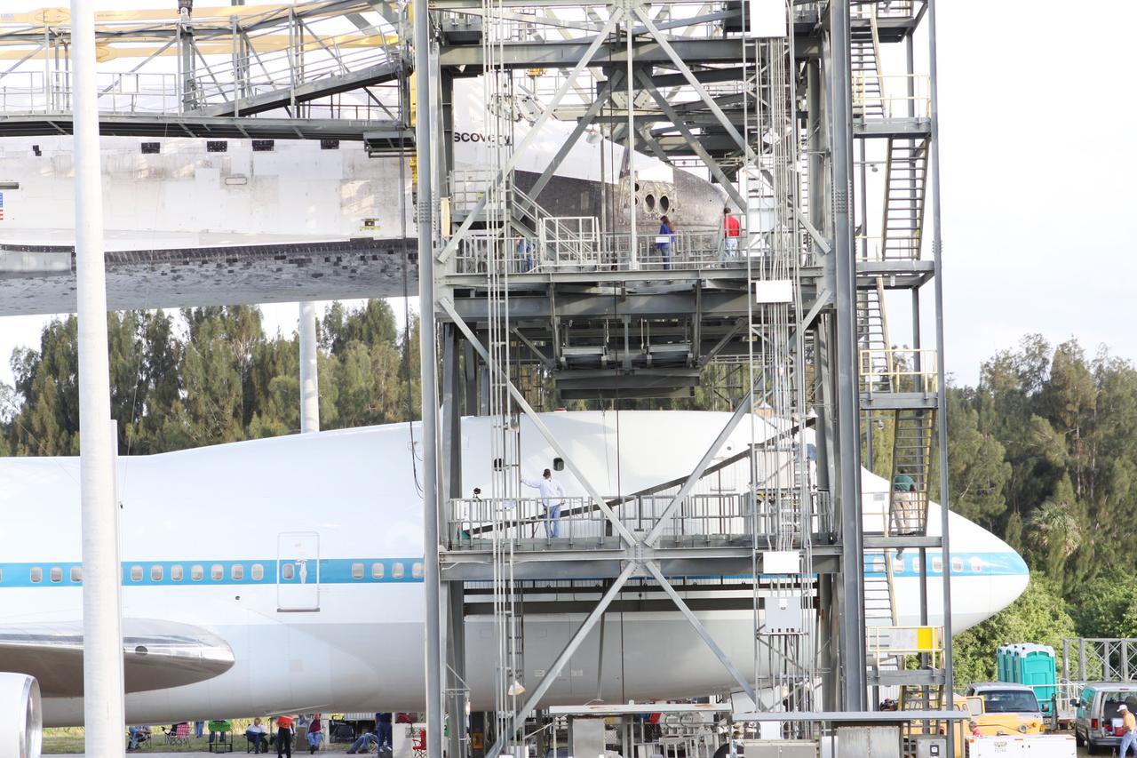 CAPE CANAVERAL, Fla. – At the Shuttle Landing Facility at NASA’s Kennedy Space Center in Florida, the Shuttle Carrier Aircraft is in position under space shuttle Discovery in the mate-demate device for mating operations to begin.     The device, known as the MDD, is a large gantry-like steel structure used to hoist a shuttle off the ground and position it onto the back of the aircraft, or SCA. The SCA is a Boeing 747 jet, originally manufactured for commercial use, which was modified by NASA to transport the shuttles between destinations on Earth. The SCA designated NASA 905 is assigned to the remaining ferry missions, delivering the shuttles to their permanent public display sites.  NASA 905 is scheduled to ferry Discovery to the Washington Dulles International Airport in Virginia on April 17, after which the shuttle will be placed on display in the Smithsonian's National Air and Space Museum Steven F. Udvar-Hazy Center. For more information on the SCA, visit http://www.nasa.gov/centers/dryden/news/FactSheets/FS-013-DFRC.html. For more information on shuttle transition and retirement activities, visit http://www.nasa.gov/transition. Photo credit: NASA/Kim Shiflett