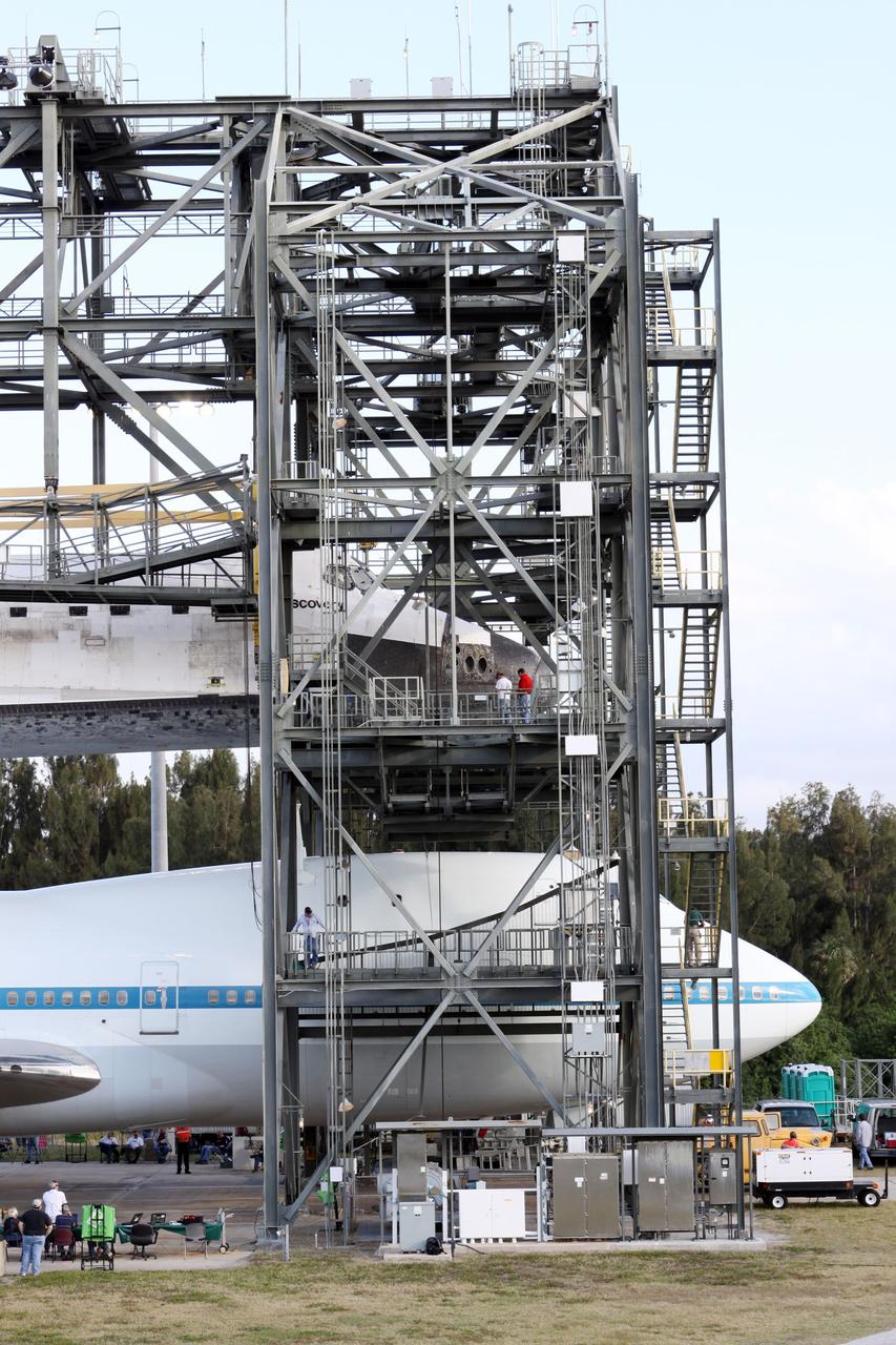 CAPE CANAVERAL, Fla. – At the Shuttle Landing Facility at NASA’s Kennedy Space Center in Florida, the Shuttle Carrier Aircraft is in position under space shuttle Discovery in the mate-demate device for mating operations to begin.     The device, known as the MDD, is a large gantry-like steel structure used to hoist a shuttle off the ground and position it onto the back of the aircraft, or SCA. The SCA is a Boeing 747 jet, originally manufactured for commercial use, which was modified by NASA to transport the shuttles between destinations on Earth. The SCA designated NASA 905 is assigned to the remaining ferry missions, delivering the shuttles to their permanent public display sites.  NASA 905 is scheduled to ferry Discovery to the Washington Dulles International Airport in Virginia on April 17, after which the shuttle will be placed on display in the Smithsonian's National Air and Space Museum Steven F. Udvar-Hazy Center. For more information on the SCA, visit http://www.nasa.gov/centers/dryden/news/FactSheets/FS-013-DFRC.html. For more information on shuttle transition and retirement activities, visit http://www.nasa.gov/transition. Photo credit: NASA/Kim Shiflett