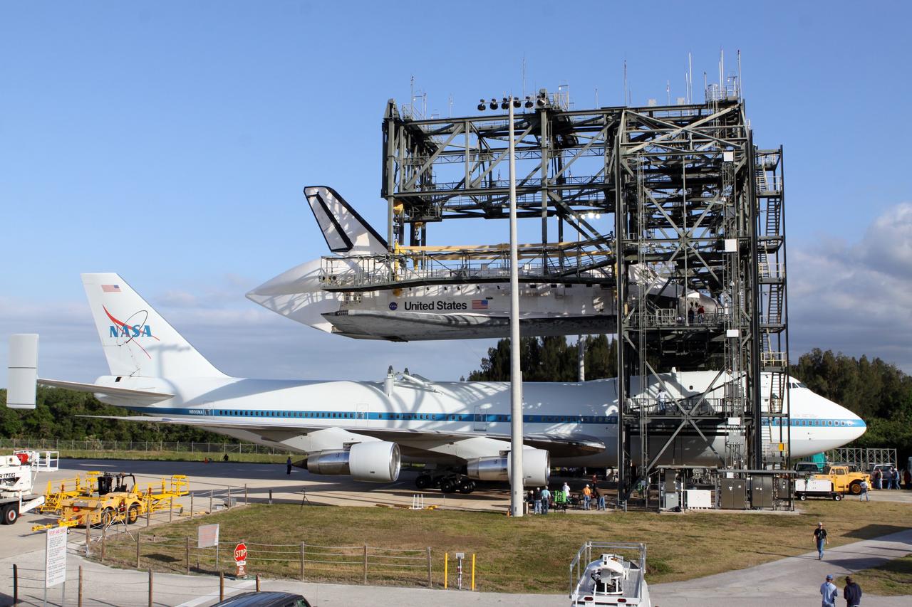 CAPE CANAVERAL, Fla. – At the Shuttle Landing Facility at NASA’s Kennedy Space Center in Florida, the Shuttle Carrier Aircraft is positioned beneath space shuttle Discovery in the mate-demate device. Discovery will be lowered and mated to the aircraft in preparation for its departure from Kennedy on Tuesday.     The device, known as the MDD, is a large gantry-like steel structure used to hoist a shuttle off the ground and position it onto the back of the aircraft, or SCA. The SCA is a Boeing 747 jet, originally manufactured for commercial use, which was modified by NASA to transport the shuttles between destinations on Earth. The SCA designated NASA 905 is assigned to the remaining ferry missions, delivering the shuttles to their permanent public display sites.  NASA 905 is scheduled to ferry Discovery to the Washington Dulles International Airport in Virginia on April 17, after which the shuttle will be placed on display in the Smithsonian's National Air and Space Museum Steven F. Udvar-Hazy Center. For more information on the SCA, visit http://www.nasa.gov/centers/dryden/news/FactSheets/FS-013-DFRC.html. For more information on shuttle transition and retirement activities, visit http://www.nasa.gov/transition. Photo credit: NASA/Kim Shiflett