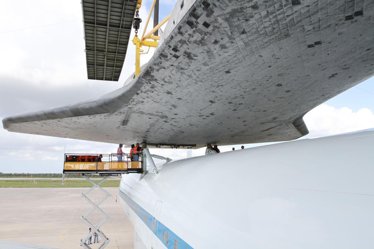 CAPE CANAVERAL, Fla. – At the Shuttle Landing Facility at NASA’s Kennedy Space Center in Florida, workers attach space shuttle Discovery to the Shuttle Carrier Aircraft in the mate-demate device.      The device, known as the MDD, is a large gantry-like steel structure used to hoist a shuttle off the ground and position it onto the back of the aircraft, or SCA. The SCA is a Boeing 747 jet, originally manufactured for commercial use, which was modified by NASA to transport the shuttles between destinations on Earth. The SCA designated NASA 905 is assigned to the remaining ferry missions, delivering the shuttles to their permanent public display sites.  NASA 905 is scheduled to ferry Discovery to the Washington Dulles International Airport in Virginia on April 17, after which the shuttle will be placed on display in the Smithsonian's National Air and Space Museum Steven F. Udvar-Hazy Center. For more information on the SCA, visit http://www.nasa.gov/centers/dryden/news/FactSheets/FS-013-DFRC.html. For more information on shuttle transition and retirement activities, visit http://www.nasa.gov/transition. Photo credit: NASA/Kim Shiflett