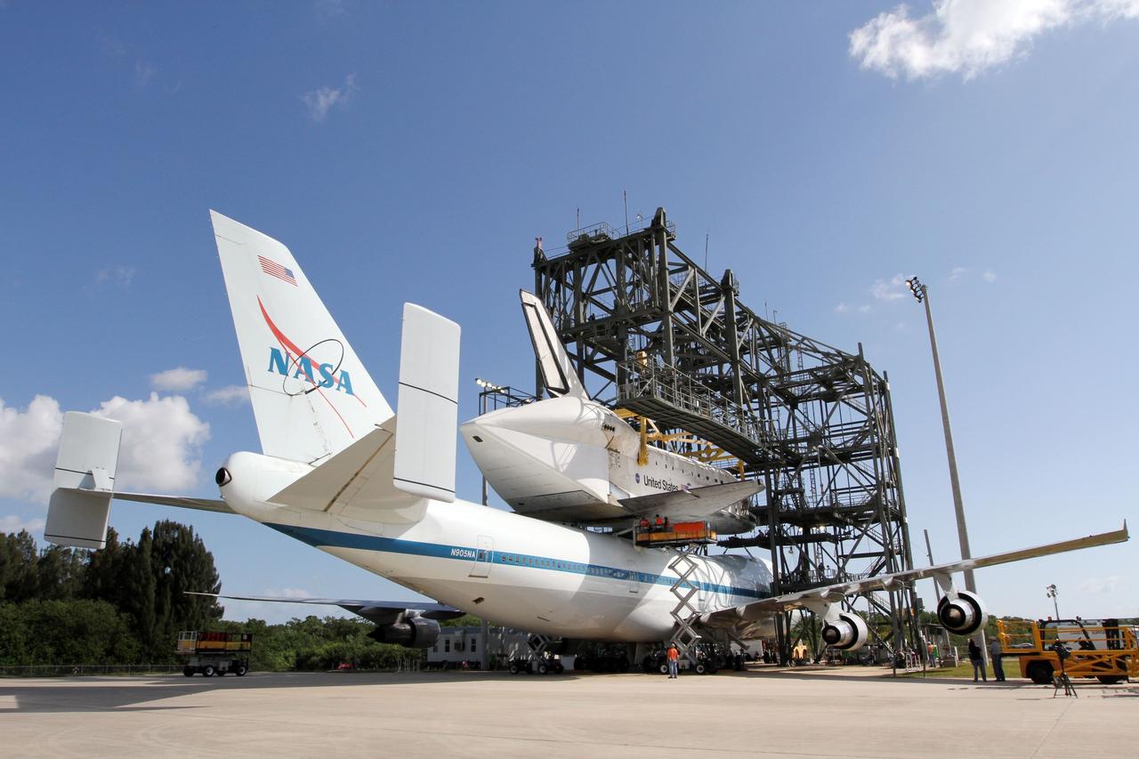 CAPE CANAVERAL, Fla. – At the Shuttle Landing Facility at NASA’s Kennedy Space Center in Florida, the mating of space shuttle Discovery to the Shuttle Carrier Aircraft is under way in the mate-demate device.    The device, known as the MDD, is a large gantry-like steel structure used to hoist a shuttle off the ground and position it onto the back of the aircraft, or SCA. The SCA is a Boeing 747 jet, originally manufactured for commercial use, which was modified by NASA to transport the shuttles between destinations on Earth. The SCA designated NASA 905 is assigned to the remaining ferry missions, delivering the shuttles to their permanent public display sites.  NASA 905 is scheduled to ferry Discovery to the Washington Dulles International Airport in Virginia on April 17, after which the shuttle will be placed on display in the Smithsonian's National Air and Space Museum Steven F. Udvar-Hazy Center. For more information on the SCA, visit http://www.nasa.gov/centers/dryden/news/FactSheets/FS-013-DFRC.html. For more information on shuttle transition and retirement activities, visit http://www.nasa.gov/transition. Photo credit: NASA/Kim Shiflett