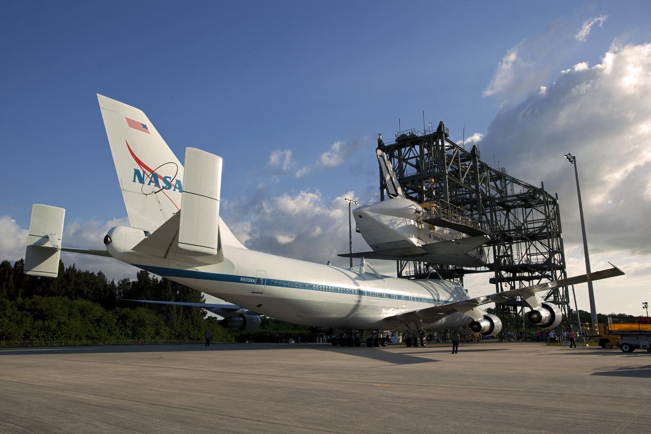 CAPE CANAVERAL, Fla. – At the Shuttle Landing Facility at NASA’s Kennedy Space Center in Florida, the Shuttle Carrier Aircraft moves into position under space shuttle Discovery suspended 60 feet off the ground in the mate-demate device.      The device, known as the MDD, is a large gantry-like steel structure used to hoist a shuttle off the ground and position it onto the back of the aircraft, or SCA. The SCA is a Boeing 747 jet, originally manufactured for commercial use, which was modified by NASA to transport the shuttles between destinations on Earth. This SCA, designated NASA 905, is assigned to the remaining ferry missions, delivering the shuttles to their permanent public display sites.  NASA 905 is scheduled to ferry Discovery to the Washington Dulles International Airport in Virginia on April 17, after which the shuttle will be placed on display in the Smithsonian's National Air and Space Museum Steven F. Udvar-Hazy Center. For more information on the SCA, visit http://www.nasa.gov/centers/dryden/news/FactSheets/FS-013-DFRC.html. For more information on shuttle transition and retirement activities, visit http://www.nasa.gov/transition. Photo credit: NASA/Dimitri Gerondidakis