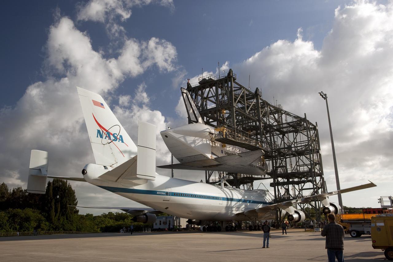 CAPE CANAVERAL, Fla. – At the Shuttle Landing Facility at NASA’s Kennedy Space Center in Florida, the Shuttle Carrier Aircraft is in position under space shuttle Discovery in the mate-demate device for mating operations to begin.     The device, known as the MDD, is a large gantry-like steel structure used to hoist a shuttle off the ground and position it onto the back of the aircraft, or SCA. The SCA is a Boeing 747 jet, originally manufactured for commercial use, which was modified by NASA to transport the shuttles between destinations on Earth. This SCA, designated NASA 905, is assigned to the remaining ferry missions, delivering the shuttles to their permanent public display sites.  NASA 905 is scheduled to ferry Discovery to the Washington Dulles International Airport in Virginia on April 17, after which the shuttle will be placed on display in the Smithsonian's National Air and Space Museum Steven F. Udvar-Hazy Center. For more information on the SCA, visit http://www.nasa.gov/centers/dryden/news/FactSheets/FS-013-DFRC.html. For more information on shuttle transition and retirement activities, visit http://www.nasa.gov/transition. Photo credit: NASA/Dimitri Gerondidakis