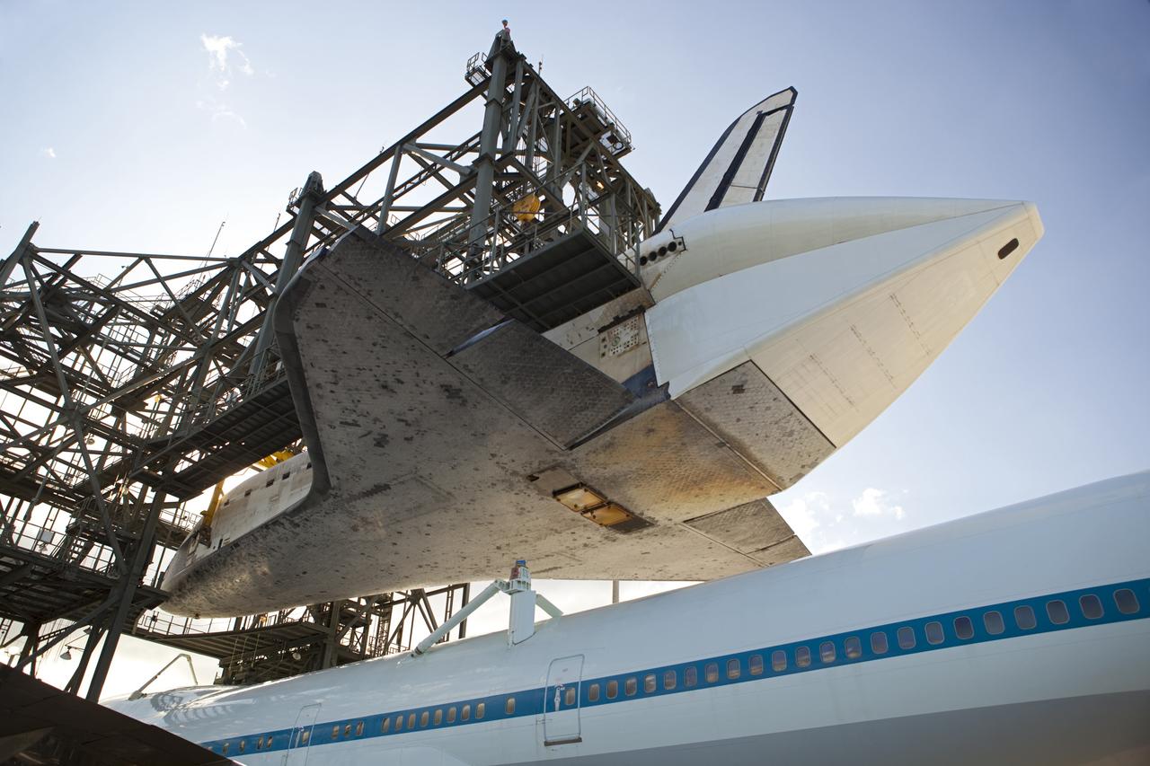CAPE CANAVERAL, Fla. – At the Shuttle Landing Facility at NASA’s Kennedy Space Center in Florida, space shuttle Discovery is lowered onto the Shuttle Carrier Aircraft in the mate-demate device during mating operations. The device, known as the MDD, is a large gantry-like steel structure used to hoist a shuttle off the ground and position it onto the back of the aircraft, or SCA. The SCA is a Boeing 747 jet, originally manufactured for commercial use, which was modified by NASA to transport the shuttles between destinations on Earth. This SCA, designated NASA 905, is assigned to the remaining ferry missions, delivering the shuttles to their permanent public display sites. NASA 905 is scheduled to ferry Discovery to the Washington Dulles International Airport in Virginia on April 17, after which the shuttle will be placed on display in the Smithsonian's National Air and Space Museum Steven F. Udvar-Hazy Center. For more information on the SCA, visit http://www.nasa.gov/centers/dryden/news/FactSheets/FS-013-DFRC.html. For more information on shuttle transition and retirement activities, visit http://www.nasa.gov/transition. Photo credit: NASA/Dimitri Gerondidakis