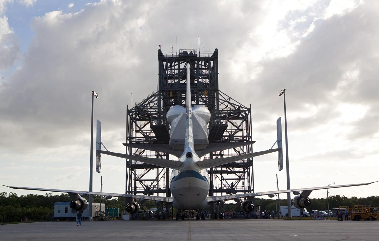CAPE CANAVERAL, Fla. – At the Shuttle Landing Facility at NASA’s Kennedy Space Center in Florida, space shuttle Discovery is lowered onto the Shuttle Carrier Aircraft in the mate-demate device during mating operations.    The device, known as the MDD, is a large gantry-like steel structure used to hoist a shuttle off the ground and position it onto the back of the aircraft, or SCA. The SCA is a Boeing 747 jet, originally manufactured for commercial use, which was modified by NASA to transport the shuttles between destinations on Earth. This SCA, designated NASA 905, is assigned to the remaining ferry missions, delivering the shuttles to their permanent public display sites.  NASA 905 is scheduled to ferry Discovery to the Washington Dulles International Airport in Virginia on April 17, after which the shuttle will be placed on display in the Smithsonian's National Air and Space Museum Steven F. Udvar-Hazy Center. For more information on the SCA, visit http://www.nasa.gov/centers/dryden/news/FactSheets/FS-013-DFRC.html. For more information on shuttle transition and retirement activities, visit http://www.nasa.gov/transition. Photo credit: NASA/Dimitri Gerondidakis