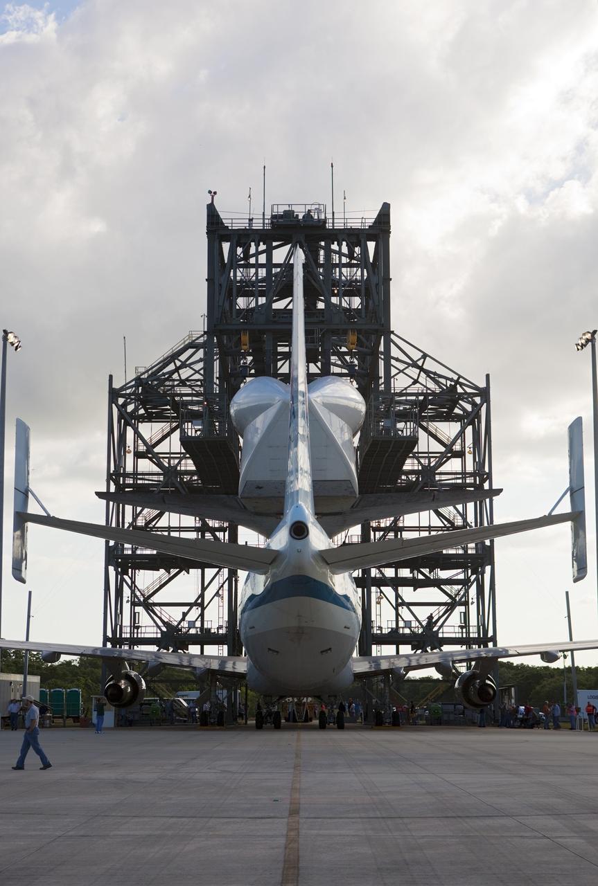 CAPE CANAVERAL, Fla. – At the Shuttle Landing Facility at NASA’s Kennedy Space Center in Florida, space shuttle Discovery is lowered onto the Shuttle Carrier Aircraft in the mate-demate device during mating operations.    The device, known as the MDD, is a large gantry-like steel structure used to hoist a shuttle off the ground and position it onto the back of the aircraft, or SCA. The SCA is a Boeing 747 jet, originally manufactured for commercial use, which was modified by NASA to transport the shuttles between destinations on Earth. This SCA, designated NASA 905, is assigned to the remaining ferry missions, delivering the shuttles to their permanent public display sites.  NASA 905 is scheduled to ferry Discovery to the Washington Dulles International Airport in Virginia on April 17, after which the shuttle will be placed on display in the Smithsonian's National Air and Space Museum Steven F. Udvar-Hazy Center. For more information on the SCA, visit http://www.nasa.gov/centers/dryden/news/FactSheets/FS-013-DFRC.html. For more information on shuttle transition and retirement activities, visit http://www.nasa.gov/transition. Photo credit: NASA/Dimitri Gerondidakis