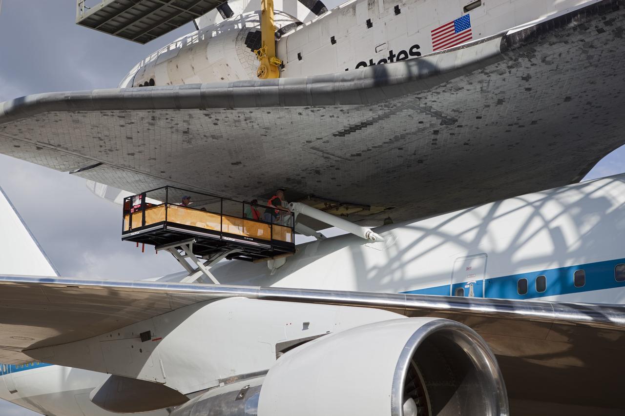 CAPE CANAVERAL, Fla. – At the Shuttle Landing Facility at NASA’s Kennedy Space Center in Florida, workers attach space shuttle Discovery to the Shuttle Carrier Aircraft in the mate-demate device.    The device, known as the MDD, is a large gantry-like steel structure used to hoist a shuttle off the ground and position it onto the back of the aircraft, or SCA. The SCA is a Boeing 747 jet, originally manufactured for commercial use, which was modified by NASA to transport the shuttles between destinations on Earth. This SCA, designated NASA 905, is assigned to the remaining ferry missions, delivering the shuttles to their permanent public display sites.  NASA 905 is scheduled to ferry Discovery to the Washington Dulles International Airport in Virginia on April 17, after which the shuttle will be placed on display in the Smithsonian's National Air and Space Museum Steven F. Udvar-Hazy Center. For more information on the SCA, visit http://www.nasa.gov/centers/dryden/news/FactSheets/FS-013-DFRC.html. For more information on shuttle transition and retirement activities, visit http://www.nasa.gov/transition. Photo credit: NASA/Dimitri Gerondidakis