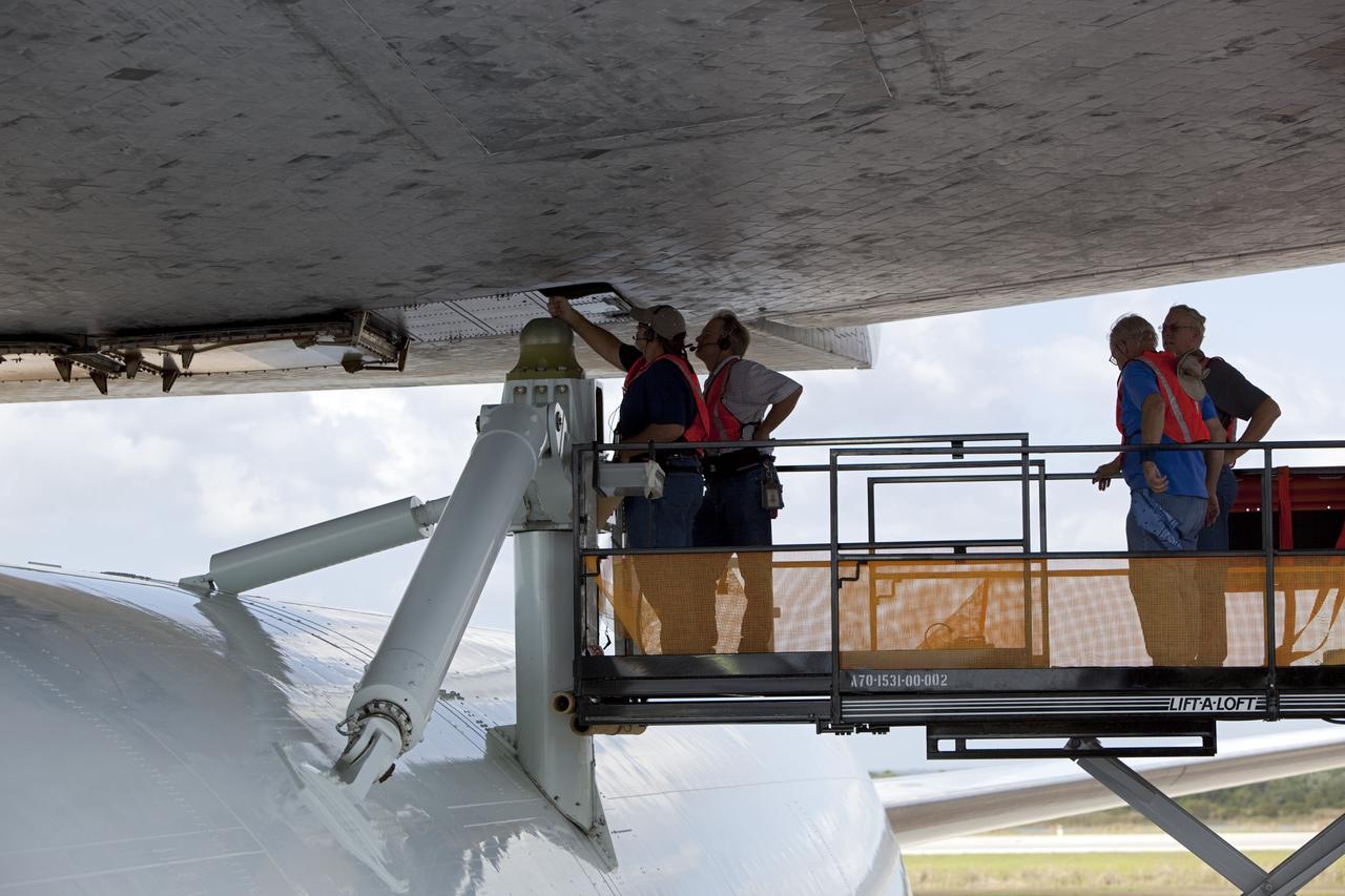 CAPE CANAVERAL, Fla. – At the Shuttle Landing Facility at NASA’s Kennedy Space Center in Florida, workers attach space shuttle Discovery to the Shuttle Carrier Aircraft in the mate-demate device.    The device, known as the MDD, is a large gantry-like steel structure used to hoist a shuttle off the ground and position it onto the back of the aircraft, or SCA. The SCA is a Boeing 747 jet, originally manufactured for commercial use, which was modified by NASA to transport the shuttles between destinations on Earth. This SCA, designated NASA 905, is assigned to the remaining ferry missions, delivering the shuttles to their permanent public display sites.  NASA 905 is scheduled to ferry Discovery to the Washington Dulles International Airport in Virginia on April 17, after which the shuttle will be placed on display in the Smithsonian's National Air and Space Museum Steven F. Udvar-Hazy Center. For more information on the SCA, visit http://www.nasa.gov/centers/dryden/news/FactSheets/FS-013-DFRC.html. For more information on shuttle transition and retirement activities, visit http://www.nasa.gov/transition. Photo credit: NASA/Dimitri Gerondidakis