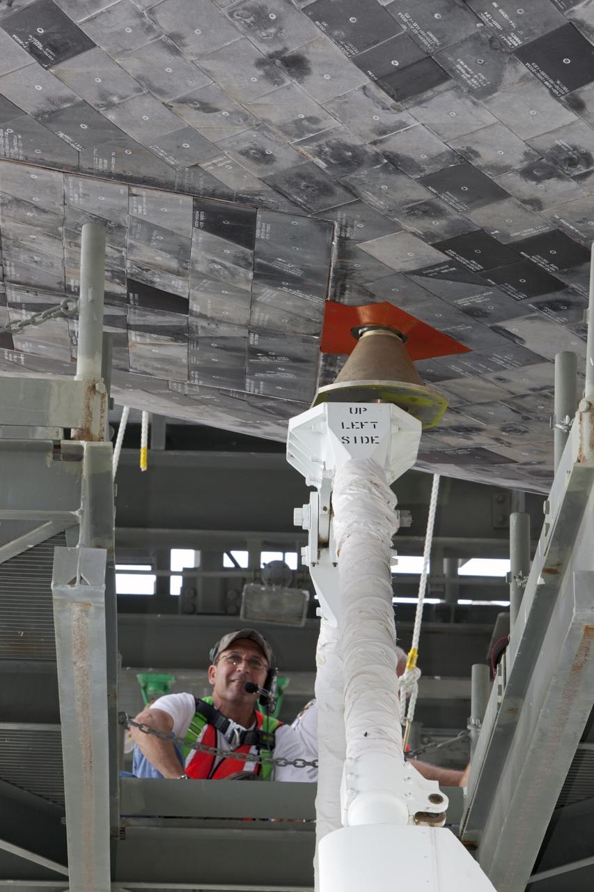 CAPE CANAVERAL, Fla. – At the Shuttle Landing Facility at NASA’s Kennedy Space Center in Florida, workers in the mate-demate device attach space shuttle Discovery to the Shuttle Carrier Aircraft.    The device, known as the MDD, is a large gantry-like steel structure used to hoist a shuttle off the ground and position it onto the back of the aircraft, or SCA. The SCA is a Boeing 747 jet, originally manufactured for commercial use, which was modified by NASA to transport the shuttles between destinations on Earth. This SCA, designated NASA 905, is assigned to the remaining ferry missions, delivering the shuttles to their permanent public display sites.  NASA 905 is scheduled to ferry Discovery to the Washington Dulles International Airport in Virginia on April 17, after which the shuttle will be placed on display in the Smithsonian's National Air and Space Museum Steven F. Udvar-Hazy Center. For more information on the SCA, visit http://www.nasa.gov/centers/dryden/news/FactSheets/FS-013-DFRC.html. For more information on shuttle transition and retirement activities, visit http://www.nasa.gov/transition. Photo credit: NASA/Dimitri Gerondidakis
