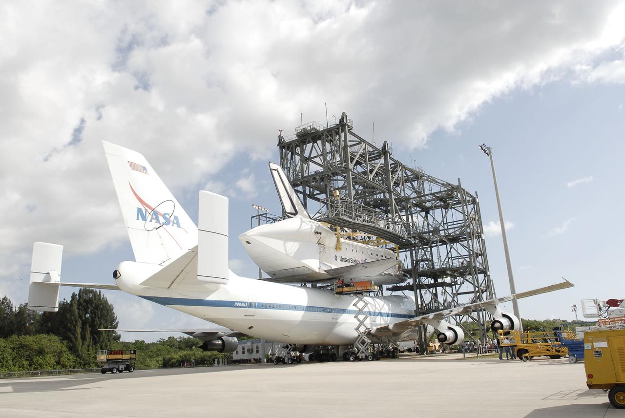 CAPE CANAVERAL, Fla. – At the Shuttle Landing Facility at NASA’s Kennedy Space Center in Florida, space shuttle Discovery is lowered onto the top of the Shuttle Carrier Aircraft in the mate-demate device as mating operations get under way.      The device, known as the MDD, is a large gantry-like steel structure used to hoist a shuttle off the ground and position it onto the back of the aircraft, or SCA. The SCA is a Boeing 747 jet, originally manufactured for commercial use, which was modified by NASA to transport the shuttles between destinations on Earth. This SCA, designated NASA 905, is assigned to the remaining ferry missions, delivering the shuttles to their permanent public display sites.  NASA 905 is scheduled to ferry Discovery to the Washington Dulles International Airport in Virginia on April 17, after which the shuttle will be placed on display in the Smithsonian's National Air and Space Museum Steven F. Udvar-Hazy Center. For more information on the SCA, visit http://www.nasa.gov/centers/dryden/news/FactSheets/FS-013-DFRC.html. For more information on shuttle transition and retirement activities, visit http://www.nasa.gov/transition. Photo credit: NASA/Tim Jacobs