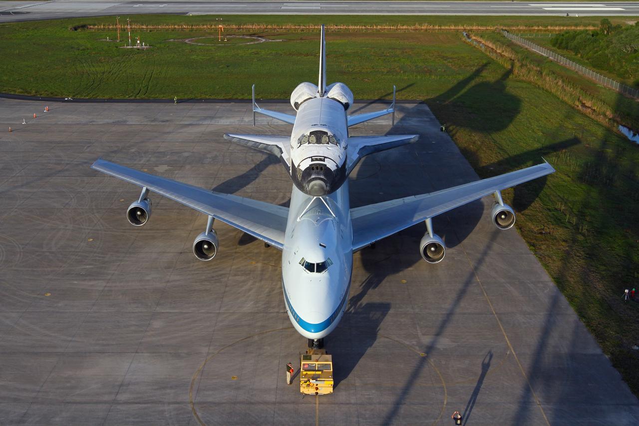 CAPE CANAVERAL, Fla. – The Shuttle Carrier Aircraft carrying space shuttle Discovery is on the ramp of the Shuttle Landing Facility at NASA’s Kennedy Space Center in Florida. Earlier, the duo backed out of the mate-demate device. Known as the MDD, the device is a large gantry-like steel structure used to hoist a shuttle off the ground and position it onto the back of the aircraft, or SCA. The SCA is a Boeing 747 jet that was originally manufactured for commercial use and modified by NASA to transport the shuttles between destinations on Earth. This SCA, designated NASA 905, is assigned to the remaining ferry missions, delivering the shuttles to their permanent public display sites. NASA 905 is scheduled to ferry Discovery to the Washington Dulles International Airport in Virginia on April 17, after which the shuttle will be placed on display in the Smithsonian's National Air and Space Museum Steven F. Udvar-Hazy Center. For more information on the SCA, visit http://www.nasa.gov/centers/dryden/news/FactSheets/FS-013-DFRC.html. For more information on shuttle transition and retirement activities, visit http://www.nasa.gov/transition. Photo credit: NASA/Kim Shiflett
