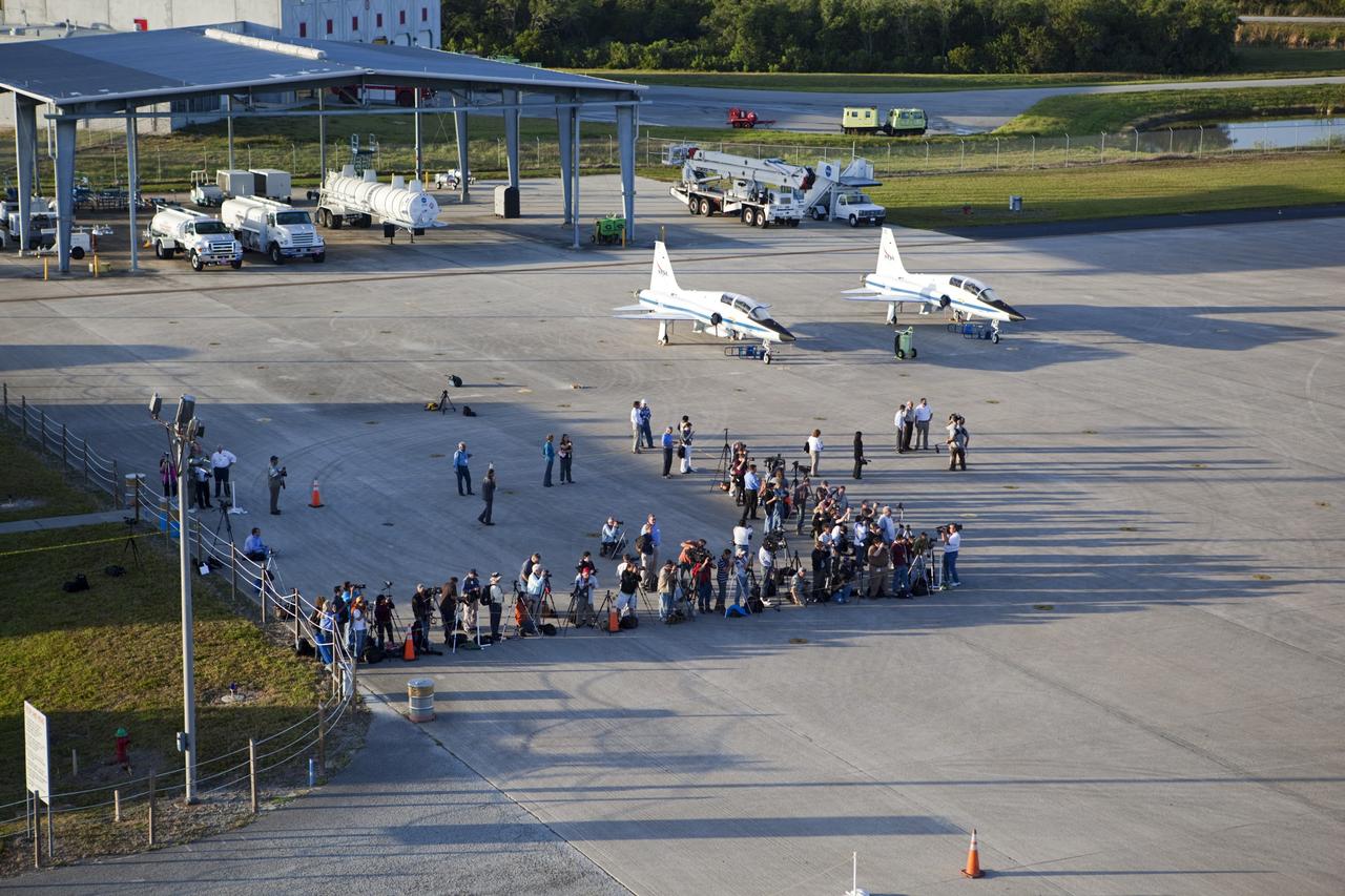 CAPE CANAVERAL, Fla. – At NASA Kennedy Space Center’s Shuttle Landing Facility in Florida, members of the media take photographs of space shuttle Discovery atop the Shuttle Carrier Aircraft, or SCA, at the mate/demate device. Known as the MDD, the devise is a large gantry-like steel structure used to hoist a shuttle off the ground and position it onto the back of the SCA. The SCA is a Boeing 747 jet that was originally manufactured for commercial use and modified by NASA to transport the shuttles between destinations on Earth. This SCA, designated NASA 905, is assigned to the remaining ferry missions, delivering the shuttles to their permanent public display sites. NASA 905 is scheduled to ferry Discovery to the Washington Dulles International Airport in Virginia on April 17, after which the shuttle will be placed on display in the Smithsonian’s National Air and Space Museum, Steven F. Udvar-Hazy Center in Chantilly, Va. For more information on the SCA, visit http://www.nasa.gov/centers/dryden/news/FactSheets/FS-013-DFRC.html. For more information on shuttle transition and retirement activities, visit http://www.nasa.gov/transition. Photo credit: NASA/Dimitri Gerondidakis