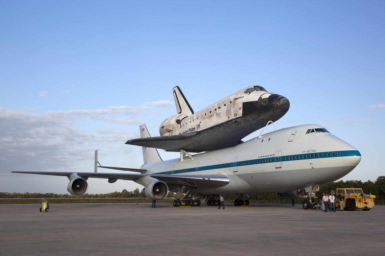 CAPE CANAVERAL, Fla. – At NASA Kennedy Space Center’s Shuttle Landing Facility in Florida, the Shuttle Carrier Aircraft, or SCA, with space shuttle Discovery attached atop, sits on the tarmac after being backed away from the mate/demate device. Known as the MDD, the devise is a large gantry-like steel structure used to hoist a shuttle off the ground and position it onto the back of the SCA. The SCA is a Boeing 747 jet that was originally manufactured for commercial use and modified by NASA to transport the shuttles between destinations on Earth. This SCA, designated NASA 905, is assigned to the remaining ferry missions, delivering the shuttles to their permanent public display sites. NASA 905 is scheduled to ferry Discovery to the Washington Dulles International Airport in Virginia on April 17, after which the shuttle will be placed on display in the Smithsonian’s National Air and Space Museum, Steven F. Udvar-Hazy Center in Chantilly, Va. For more information on the SCA, visit http://www.nasa.gov/centers/dryden/news/FactSheets/FS-013-DFRC.html. For more information on shuttle transition and retirement activities, visit http://www.nasa.gov/transition. Photo credit: NASA/Dimitri Gerondidakis