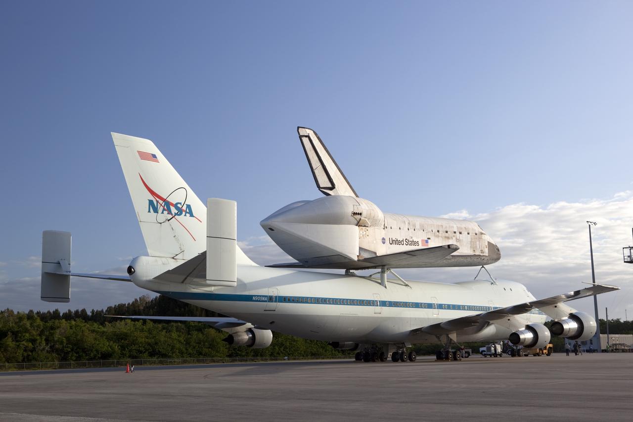 CAPE CANAVERAL, Fla. – At NASA Kennedy Space Center’s Shuttle Landing Facility in Florida, the Shuttle Carrier Aircraft, or SCA, with space shuttle Discovery attached atop, sits on the tarmac after being backed away from the mate/demate device. Known as the MDD, the devise is a large gantry-like steel structure used to hoist a shuttle off the ground and position it onto the back of the SCA. The SCA is a Boeing 747 jet that was originally manufactured for commercial use and modified by NASA to transport the shuttles between destinations on Earth. This SCA, designated NASA 905, is assigned to the remaining ferry missions, delivering the shuttles to their permanent public display sites. NASA 905 is scheduled to ferry Discovery to the Washington Dulles International Airport in Virginia on April 17, after which the shuttle will be placed on display in the Smithsonian’s National Air and Space Museum, Steven F. Udvar-Hazy Center in Chantilly, Va. For more information on the SCA, visit http://www.nasa.gov/centers/dryden/news/FactSheets/FS-013-DFRC.html. For more information on shuttle transition and retirement activities, visit http://www.nasa.gov/transition. Photo credit: NASA/Dimitri Gerondidakis