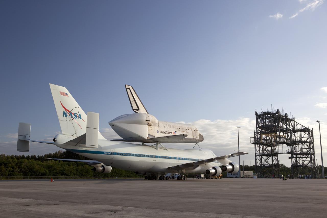 CAPE CANAVERAL, Fla. – At NASA Kennedy Space Center’s Shuttle Landing Facility in Florida, the Shuttle Carrier Aircraft, or SCA, with space shuttle Discovery attached atop, sits on the tarmac after being backed away from the mate/demate device. Known as the MDD, the devise is a large gantry-like steel structure used to hoist a shuttle off the ground and position it onto the back of the SCA. The SCA is a Boeing 747 jet that was originally manufactured for commercial use and modified by NASA to transport the shuttles between destinations on Earth. This SCA, designated NASA 905, is assigned to the remaining ferry missions, delivering the shuttles to their permanent public display sites. NASA 905 is scheduled to ferry Discovery to the Washington Dulles International Airport in Virginia on April 17, after which the shuttle will be placed on display in the Smithsonian’s National Air and Space Museum, Steven F. Udvar-Hazy Center in Chantilly, Va. For more information on the SCA, visit http://www.nasa.gov/centers/dryden/news/FactSheets/FS-013-DFRC.html. For more information on shuttle transition and retirement activities, visit http://www.nasa.gov/transition. Photo credit: NASA/Dimitri Gerondidakis