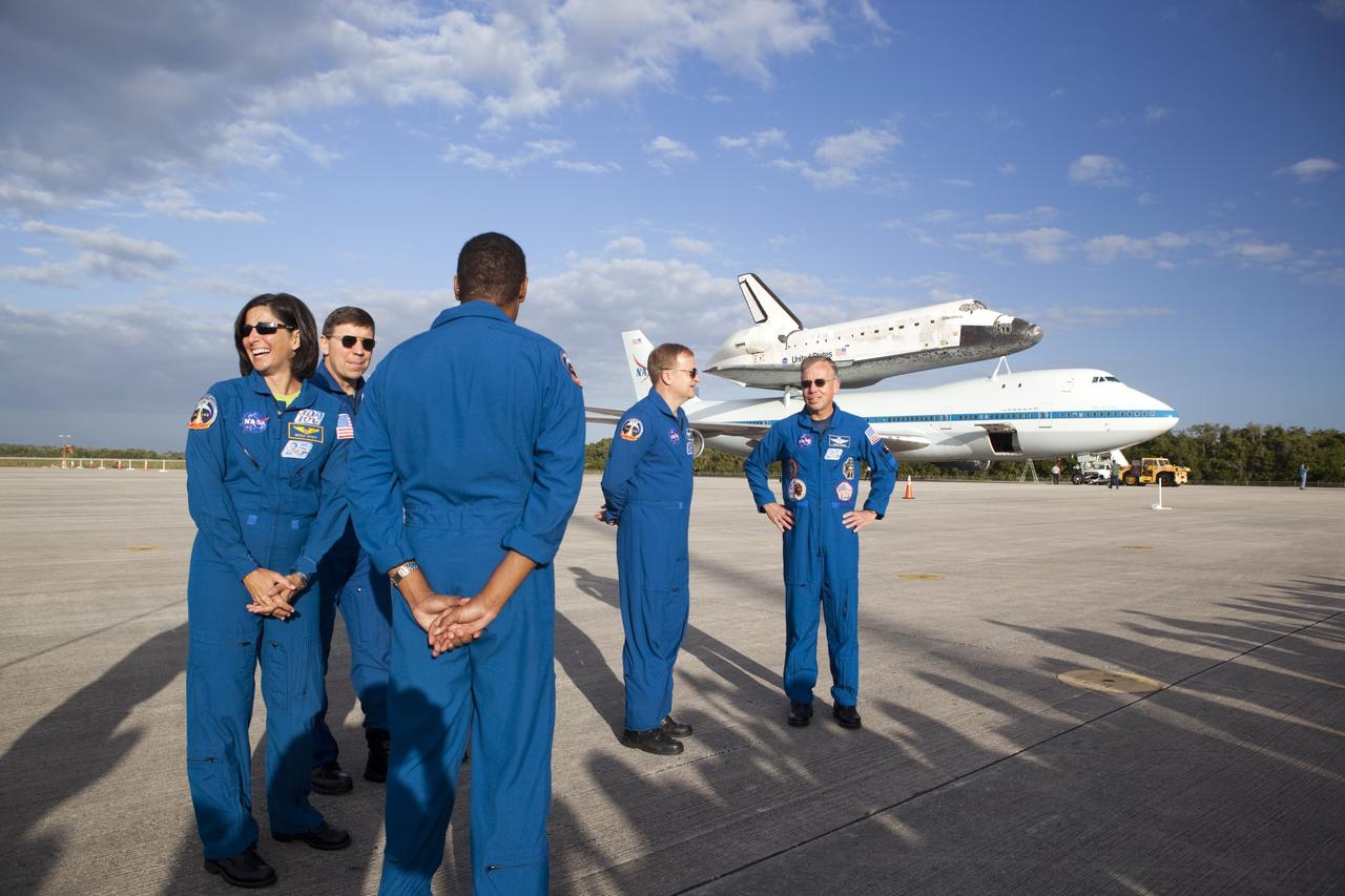 CAPE CANAVERAL, Fla. – At NASA Kennedy Space Center’s Shuttle Landing Facility in Florida, crew members of space shuttle Discovery’s last mission, STS-133, have arrived. From the left, are Mission Specialists Nicole Stott, Michael Barrett and Alvin Drew facing away, Pilot Eric Boe and Commander Steve Lindsay. In the background is the Shuttle Carrier Aircraft, or SCA, with space shuttle Discovery attached atop after being backed away from the mate/demate device. Known as the MDD, the devise is a large gantry-like steel structure used to hoist a shuttle off the ground and position it onto the back of the SCA. The SCA is a Boeing 747 jet that was originally manufactured for commercial use and modified by NASA to transport the shuttles between destinations on Earth. This SCA, designated NASA 905, is assigned to the remaining ferry missions, delivering the shuttles to their permanent public display sites. NASA 905 is scheduled to ferry Discovery to the Washington Dulles International Airport in Virginia on April 17, after which the shuttle will be placed on display in the Smithsonian’s National Air and Space Museum, Steven F. Udvar-Hazy Center in Chantilly, Va. For more information on the SCA, visit http://www.nasa.gov/centers/dryden/news/FactSheets/FS-013-DFRC.html. For more information on shuttle transition and retirement activities, visit http://www.nasa.gov/transition. Photo credit: NASA/Dimitri Gerondidakis