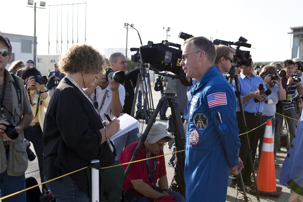 CAPE CANAVERAL, Fla. – At NASA Kennedy Space Center’s Shuttle Landing Facility in Florida, crew members of space shuttle Discovery’s last mission, STS-133, have arrived. Commander Steve Lindsay visits with the media. Also present, but not in view, are Mission Specialists Nicole Stott, Michael Barrett, Steve Bowen and Alvin Drew, and Pilot Eric Boe. The crew arrived to view the Shuttle Carrier Aircraft, or SCA, with space shuttle Discovery attached atop after being backed away from the mate/demate device. Known as the MDD, the devise is a large gantry-like steel structure used to hoist a shuttle off the ground and position it onto the back of the SCA. The SCA is a Boeing 747 jet that was originally manufactured for commercial use and modified by NASA to transport the shuttles between destinations on Earth. This SCA, designated NASA 905, is assigned to the remaining ferry missions, delivering the shuttles to their permanent public display sites. NASA 905 is scheduled to ferry Discovery to the Washington Dulles International Airport in Virginia on April 17, after which the shuttle will be placed on display in the Smithsonian’s National Air and Space Museum, Steven F. Udvar-Hazy Center in Chantilly, Va. For more information on the SCA, visit http://www.nasa.gov/centers/dryden/news/FactSheets/FS-013-DFRC.html. For more information on shuttle transition and retirement activities, visit http://www.nasa.gov/transition. Photo credit: NASA/Dimitri Gerondidakis