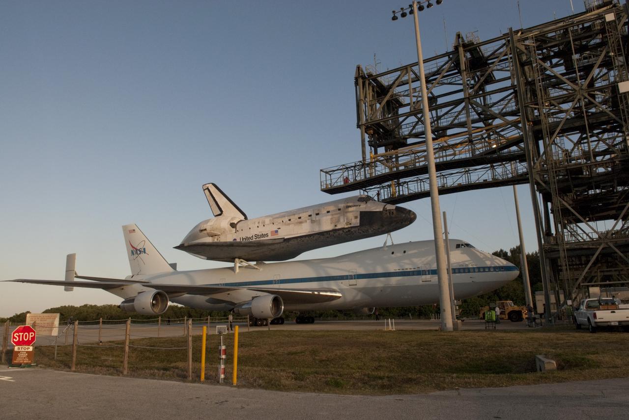 CAPE CANAVERAL, Fla. – At the Shuttle Landing Facility at NASA’s Kennedy Space Center in Florida, the Shuttle Carrier Aircraft backs away from the mate/demate device with space shuttle Discovery secured to its back.    The device, also known as the MDD, is a large gantry-like steel structure used to hoist a shuttle off the ground and position it onto the back of the aircraft, or SCA. The SCA is a Boeing 747 jet, originally manufactured for commercial use, which was modified by NASA to transport the shuttles between destinations on Earth. The SCA designated NASA 905 is assigned to the remaining ferry missions, delivering the shuttles to their permanent public display sites.  NASA 905 is scheduled to ferry Discovery to the Washington Dulles International Airport in Virginia on April 17, after which the shuttle will be placed on display in the Smithsonian's National Air and Space Museum Steven F. Udvar-Hazy Center. For more information on the SCA, visit http://www.nasa.gov/centers/dryden/news/FactSheets/FS-013-DFRC.html. For more information on shuttle transition and retirement activities, visit http://www.nasa.gov/transition. Photo credit: NASA/Tim Jacobs