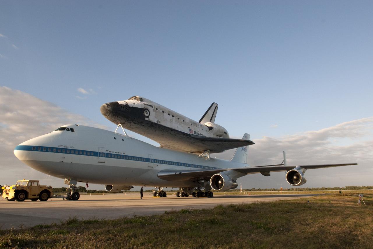 CAPE CANAVERAL, Fla. – At the Shuttle Landing Facility at NASA’s Kennedy Space Center in Florida, the Shuttle Carrier Aircraft with space shuttle Discovery secured to its back is parked on the tarmac awaiting departure from Kennedy tomorrow morning.    The aircraft, also known as an SCA, is a Boeing 747 jet, originally manufactured for commercial use, which was modified by NASA to transport the shuttles between destinations on Earth. The SCA designated NASA 905 is assigned to the remaining ferry missions, delivering the shuttles to their permanent public display sites.  NASA 905 is scheduled to ferry Discovery to the Washington Dulles International Airport in Virginia on April 17, after which the shuttle will be placed on display in the Smithsonian's National Air and Space Museum Steven F. Udvar-Hazy Center. For more information on the SCA, visit http://www.nasa.gov/centers/dryden/news/FactSheets/FS-013-DFRC.html. For more information on shuttle transition and retirement activities, visit http://www.nasa.gov/transition. Photo credit: NASA/Tim Jacobs
