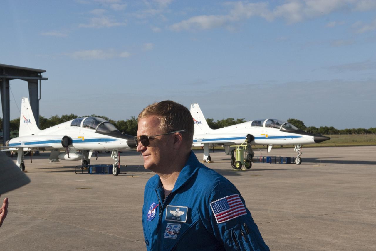 CAPE CANAVERAL, Fla. – At the Shuttle Landing Facility at NASA’s Kennedy Space Center in Florida, STS-133 Pilot Eric Boe talks to media representatives with NASA T-38 jets in the background.  Boe was a member of the crew to fly on Discovery’s final mission in February and March 2011.  Other members of the STS-133 crew were Commander Steve Lindsey, and Mission Specialists Nicole Stott, Michael Barratt, Alvin Drew and Steve Bowen. Discovery is scheduled to depart from Kennedy for the final time tomorrow morning on the back of a Shuttle Carrier Aircraft.    Also known as an SCA, the aircraft is a Boeing 747 jet, originally manufactured for commercial use, which was modified by NASA to transport the shuttles between destinations on Earth. The SCA designated NASA 905 is assigned to the remaining ferry missions, delivering the shuttles to their permanent public display sites.  NASA 905 is scheduled to ferry Discovery to the Washington Dulles International Airport in Virginia on April 17, after which the shuttle will be placed on display in the Smithsonian's National Air and Space Museum Steven F. Udvar-Hazy Center. For more information on the SCA, visit http://www.nasa.gov/centers/dryden/news/FactSheets/FS-013-DFRC.html. For more information on shuttle transition and retirement activities, visit http://www.nasa.gov/transition. Photo credit: NASA/Tim Jacobs
