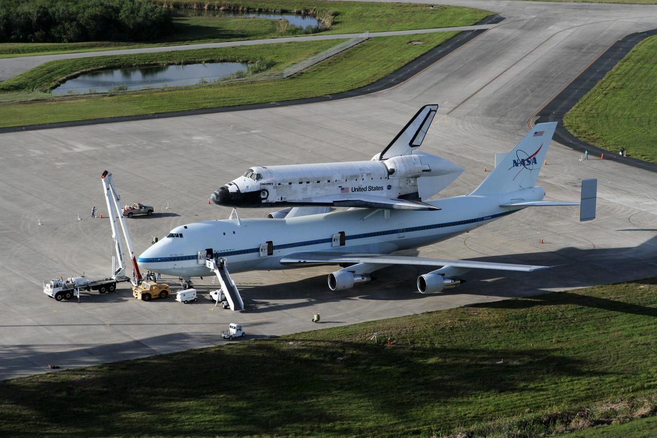 CAPE CANAVERAL, Fla. – This is an aerial view of space shuttle Discovery bolted to the top of a Shuttle Carrier Aircraft SCA on the ramp of the Shuttle Landing Facility SLF at NASA’s Kennedy Space Center in Florida. Discovery's last crew members are expected to be at the SLF, along with Kennedy employees and guests, as the center says goodbye to the agency's most-flown shuttle on April 17. The SCA, designated NASA 905, will ferry Discovery to the Washington Dulles International Airport in Virginia, after which the shuttle will be moved for public display in the Smithsonian's National Air and Space Museum Steven F. Udvar-Hazy Center on April 19.            For more information on the SCA, visit http://www.nasa.gov/centers/dryden/news/FactSheets/FS-013-DFRC.html. For more information on shuttle transition and retirement activities, visit http://www.nasa.gov/transition. Photo credit: NASA/Kim Shiflett