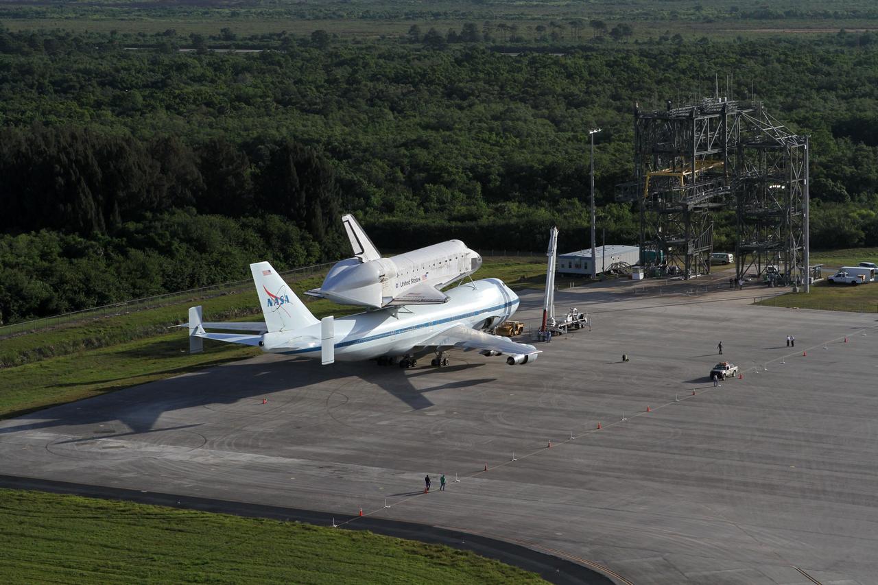 CAPE CANAVERAL, Fla. – This is an aerial view of space shuttle Discovery bolted to the top of a Shuttle Carrier Aircraft SCA on the ramp of the Shuttle Landing Facility SLF at NASA’s Kennedy Space Center in Florida. The mate/demate device, known as the MDD, also is in view and is where transition and retirement teams prepared the duo for the ferry flight. Discovery's last crew members are expected to be at the SLF, along with Kennedy employees and guests, as the center says goodbye to the agency's most-flown shuttle on April 17. The SCA, designated NASA 905, will ferry Discovery to the Washington Dulles International Airport in Virginia, after which the shuttle will be moved for public display in the Smithsonian's National Air and Space Museum Steven F. Udvar-Hazy Center on April 19.            For more information on the SCA, visit http://www.nasa.gov/centers/dryden/news/FactSheets/FS-013-DFRC.html. For more information on shuttle transition and retirement activities, visit http://www.nasa.gov/transition. Photo credit: NASA/Kim Shiflett
