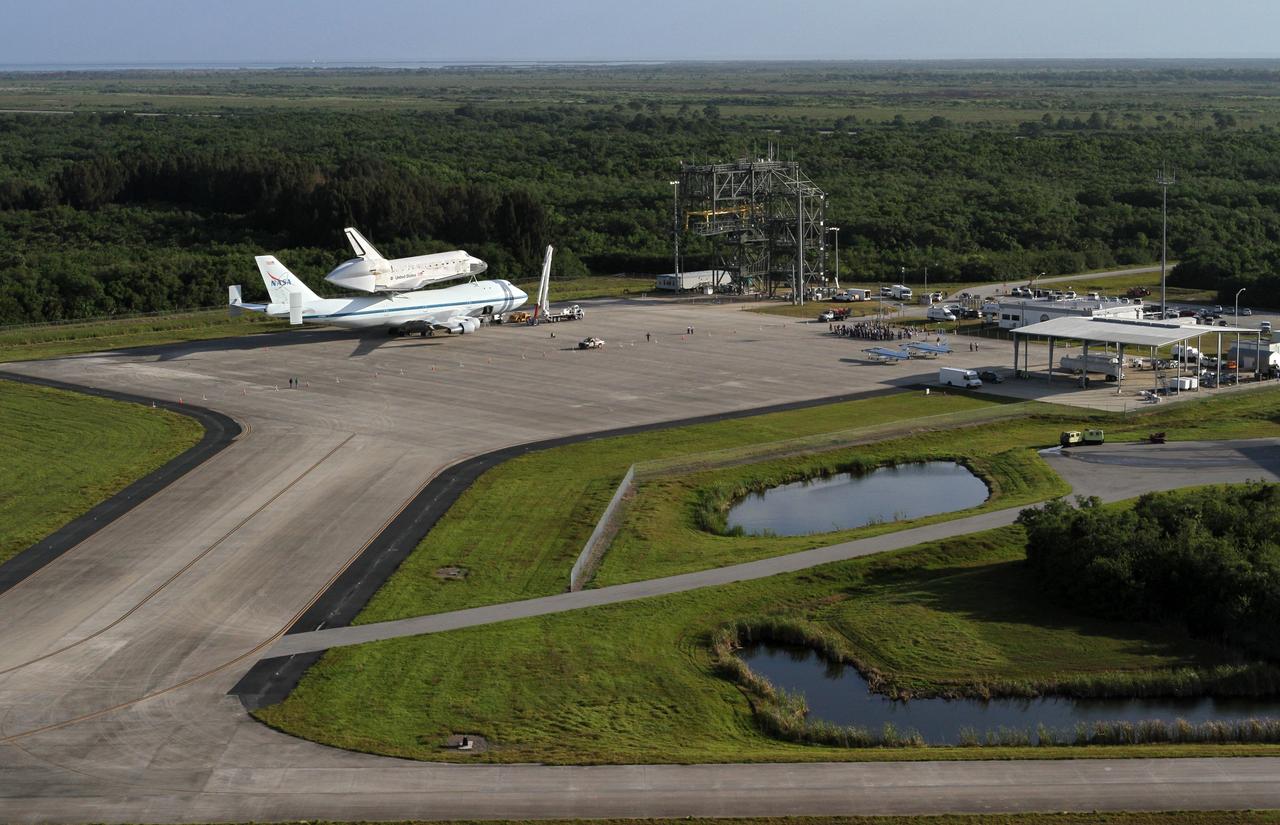 CAPE CANAVERAL, Fla. – This is an aerial view of space shuttle Discovery bolted to the top of a Shuttle Carrier Aircraft SCA on the ramp of the Shuttle Landing Facility SLF at NASA’s Kennedy Space Center in Florida. Discovery's last crew members are expected to be at the SLF, along with Kennedy employees and guests, as the center says goodbye to the agency's most-flown shuttle on April 17. The SCA, designated NASA 905, will ferry Discovery to the Washington Dulles International Airport in Virginia, after which the shuttle will be moved for public display in the Smithsonian's National Air and Space Museum Steven F. Udvar-Hazy Center on April 19.          For more information on the SCA, visit http://www.nasa.gov/centers/dryden/news/FactSheets/FS-013-DFRC.html. For more information on shuttle transition and retirement activities, visit http://www.nasa.gov/transition. Photo credit: NASA/Kim Shiflett