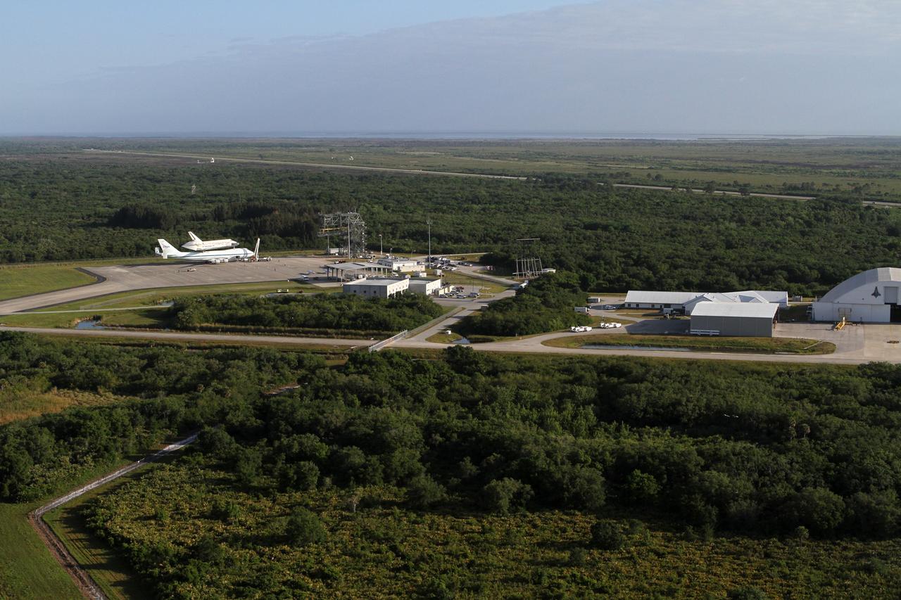 CAPE CANAVERAL, Fla. – This is an aerial view of space shuttle Discovery bolted to the top of a Shuttle Carrier Aircraft SCA on the ramp of the Shuttle Landing Facility SLF at NASA’s Kennedy Space Center in Florida. Discovery's last crew members are expected to be at the SLF, along with Kennedy employees and guests, as the center says goodbye to the agency's most-flown shuttle on April 17. The SCA, designated NASA 905, will ferry Discovery to the Washington Dulles International Airport in Virginia, after which the shuttle will be moved for public display in the Smithsonian's National Air and Space Museum Steven F. Udvar-Hazy Center on April 19.            For more information on the SCA, visit http://www.nasa.gov/centers/dryden/news/FactSheets/FS-013-DFRC.html. For more information on shuttle transition and retirement activities, visit http://www.nasa.gov/transition. Photo credit: NASA/Kim Shiflett