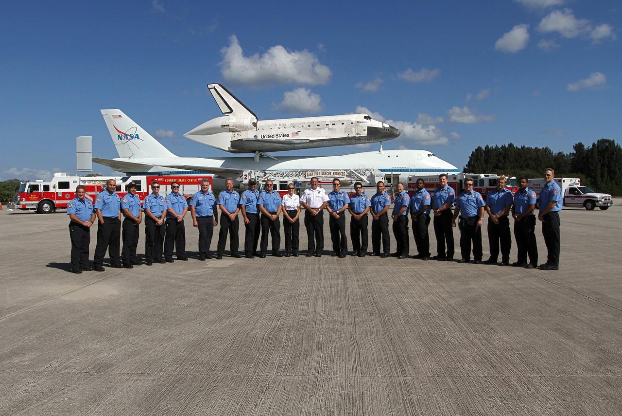 CAPE CANAVERAL, Fla. – NASA Kennedy Space Center’s Fire and Rescue Team poses for a group portrait with space shuttle Discovery atop the Shuttle Carrier Aircraft at Kennedy’s Shuttle Landing Facility.    This carrier aircraft, designated NASA 905, is scheduled to ferry Discovery to the Washington Dulles International Airport in Virginia on April 17, and is assigned to all remaining ferry missions, delivering the shuttles to their permanent public display sites.  After its arrival at Dulles, Discovery will be placed on display in the Smithsonian's National Air and Space Museum Steven F. Udvar-Hazy Center on April 19. For more information on the SCA, visit http://www.nasa.gov/centers/dryden/news/FactSheets/FS-013-DFRC.html. For more information on shuttle transition and retirement activities, visit http://www.nasa.gov/transition. Photo credit: NASA/Kim Shiflett