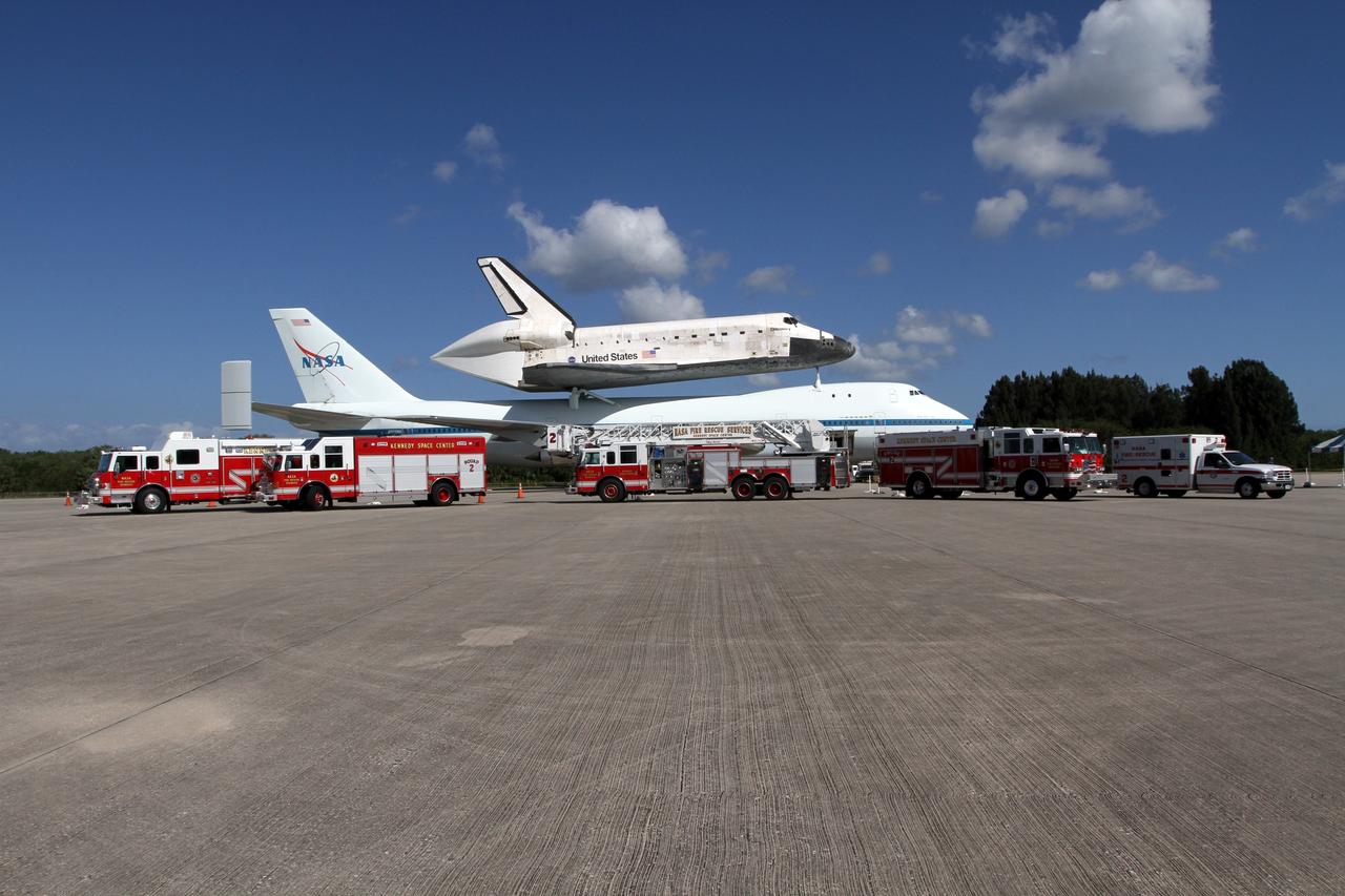 CAPE CANAVERAL, Fla. – NASA Kennedy Space Center’s Fire and Rescue vehicles are lined up for a group portrait in front of space shuttle Discovery atop the Shuttle Carrier Aircraft at Kennedy’s Shuttle Landing Facility.    This carrier aircraft, designated NASA 905, is scheduled to ferry Discovery to the Washington Dulles International Airport in Virginia on April 17, and is assigned to all remaining ferry missions, delivering the shuttles to their permanent public display sites.  After its arrival at Dulles, Discovery will be placed on display in the Smithsonian's National Air and Space Museum Steven F. Udvar-Hazy Center on April 19. For more information on the SCA, visit http://www.nasa.gov/centers/dryden/news/FactSheets/FS-013-DFRC.html. For more information on shuttle transition and retirement activities, visit http://www.nasa.gov/transition. Photo credit: NASA/Kim Shiflett