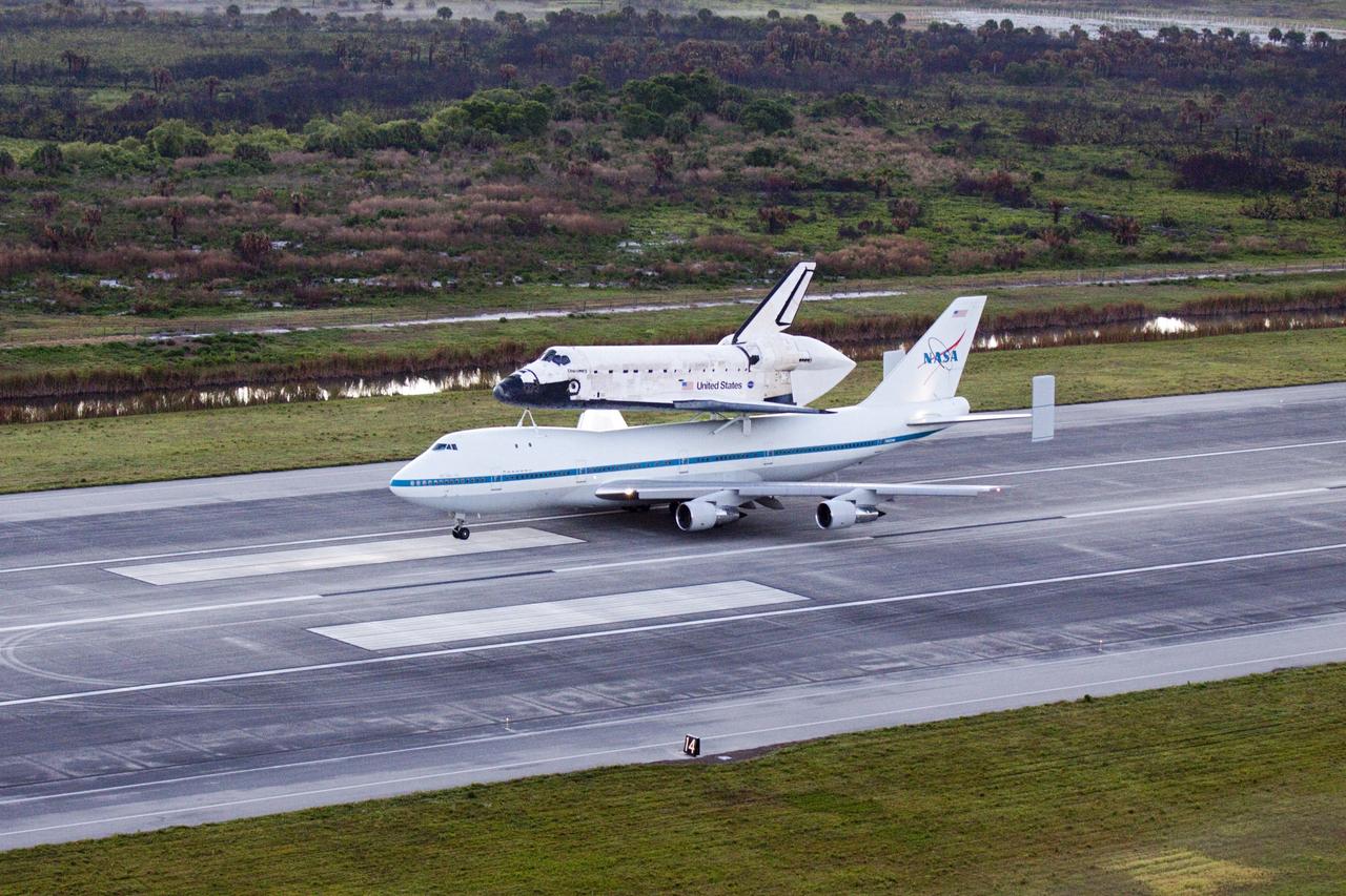 CAPE CANAVERAL, Fla. – In the early morning hours at NASA Kennedy Space Center’s Shuttle Landing Facility in Florida, the Shuttle Carrier Aircraft, or SCA, with space shuttle Discovery secured atop, taxies down the runway for a takeoff at 7 a.m. EDT to deliver Discovery to its new home. The aircraft, known as an SCA, is a Boeing 747 jet, originally manufactured for commercial use, which was modified by NASA to transport the shuttles between destinations on Earth. This SCA, designated NASA 905, is assigned to the remaining ferry missions, delivering the shuttles to their permanent public display sites. NASA 905 is scheduled to ferry Discovery to the Washington Dulles International Airport in Virginia on April 17, after which the shuttle will be placed on display in the Smithsonian’s National Air and Space Museum, Steven F. Udvar-Hazy Center in Chantilly, Va. For more information on the SCA, visit http://www.nasa.gov/centers/dryden/news/FactSheets/FS-013-DFRC.html. For more information on shuttle transition and retirement activities, visit http://www.nasa.gov/transition. Photo credit: NASA/Glenn Benson