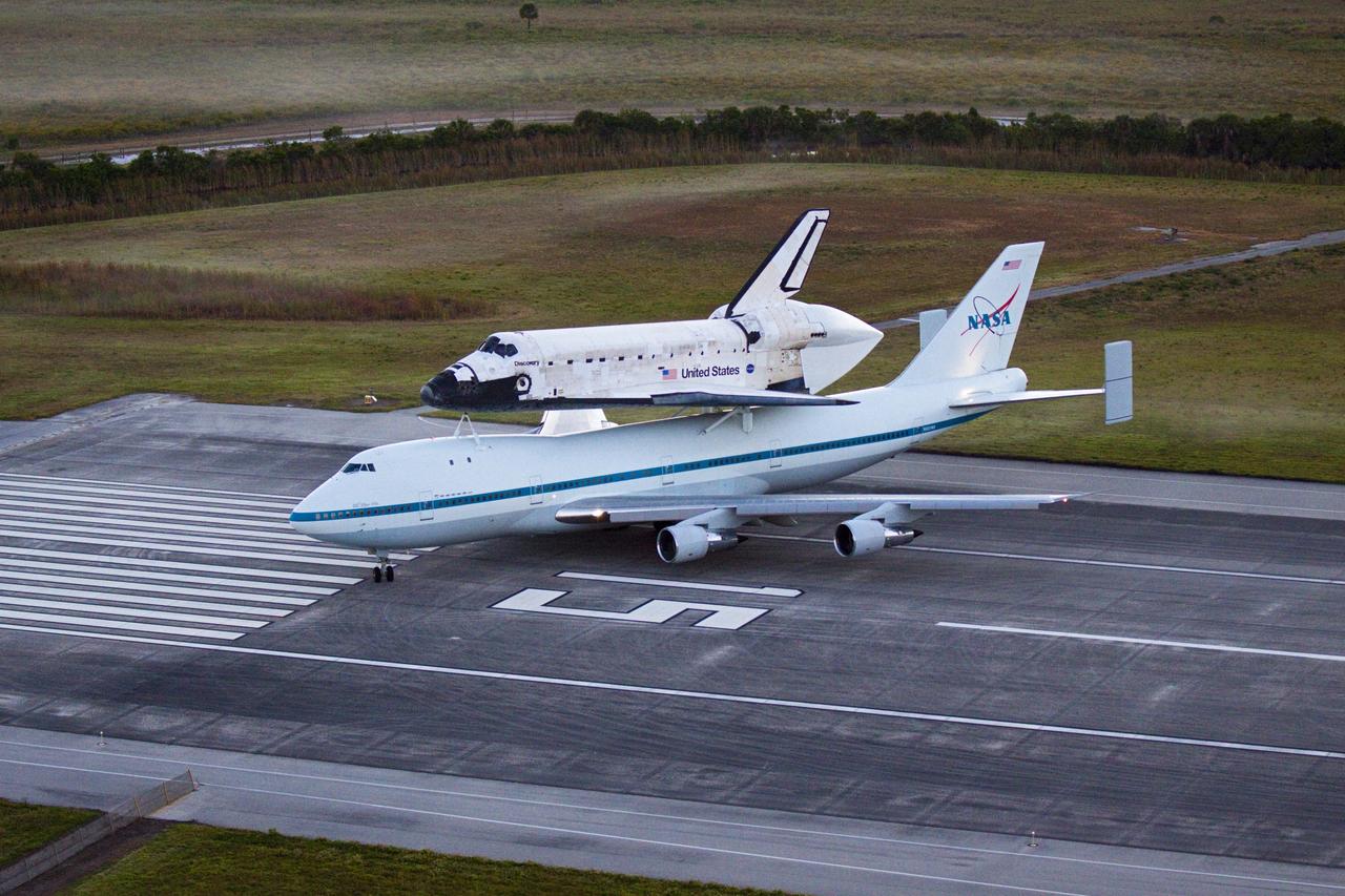 CAPE CANAVERAL, Fla. – In the early morning hours at NASA Kennedy Space Center’s Shuttle Landing Facility in Florida, the Shuttle Carrier Aircraft, or SCA, with space shuttle Discovery secured atop, begins to make the turn on runway 15 for a takeoff at 7 a.m. EDT to deliver Discovery to its new home. The aircraft, known as an SCA, is a Boeing 747 jet, originally manufactured for commercial use, which was modified by NASA to transport the shuttles between destinations on Earth. This SCA, designated NASA 905, is assigned to the remaining ferry missions, delivering the shuttles to their permanent public display sites. NASA 905 is scheduled to ferry Discovery to the Washington Dulles International Airport in Virginia on April 17, after which the shuttle will be placed on display in the Smithsonian’s National Air and Space Museum, Steven F. Udvar-Hazy Center in Chantilly, Va. For more information on the SCA, visit http://www.nasa.gov/centers/dryden/news/FactSheets/FS-013-DFRC.html. For more information on shuttle transition and retirement activities, visit http://www.nasa.gov/transition. Photo credit: NASA/Glenn Benson