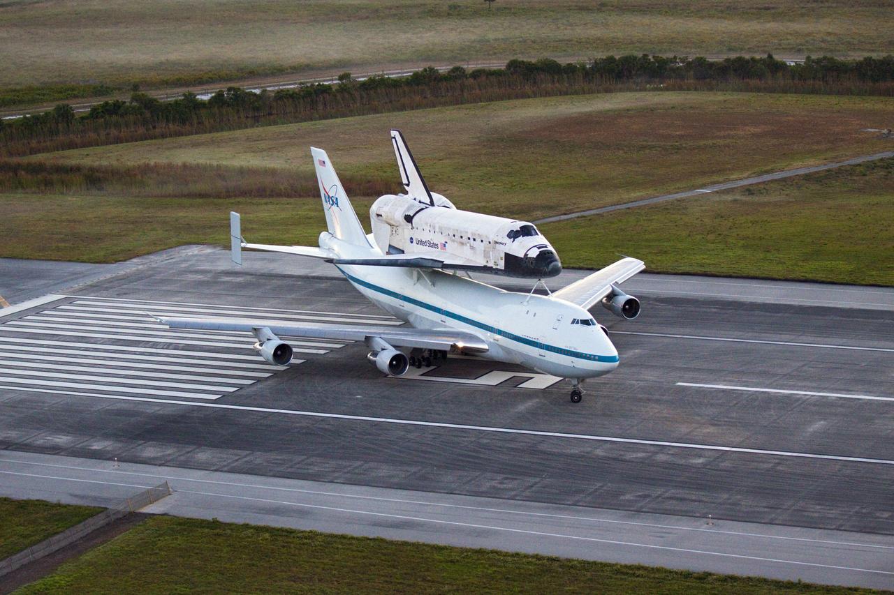 CAPE CANAVERAL, Fla. – In the early morning hours at NASA Kennedy Space Center’s Shuttle Landing Facility in Florida, the Shuttle Carrier Aircraft, or SCA, with space shuttle Discovery secured atop, completes the turn on runway 15 in preparation for a takeoff at 7 a.m. EDT to deliver Discovery to its new home. The aircraft, known as an SCA, is a Boeing 747 jet, originally manufactured for commercial use, which was modified by NASA to transport the shuttles between destinations on Earth. This SCA, designated NASA 905, is assigned to the remaining ferry missions, delivering the shuttles to their permanent public display sites. NASA 905 is scheduled to ferry Discovery to the Washington Dulles International Airport in Virginia on April 17, after which the shuttle will be placed on display in the Smithsonian’s National Air and Space Museum, Steven F. Udvar-Hazy Center in Chantilly, Va. For more information on the SCA, visit http://www.nasa.gov/centers/dryden/news/FactSheets/FS-013-DFRC.html. For more information on shuttle transition and retirement activities, visit http://www.nasa.gov/transition. Photo credit: NASA/Glenn Benson