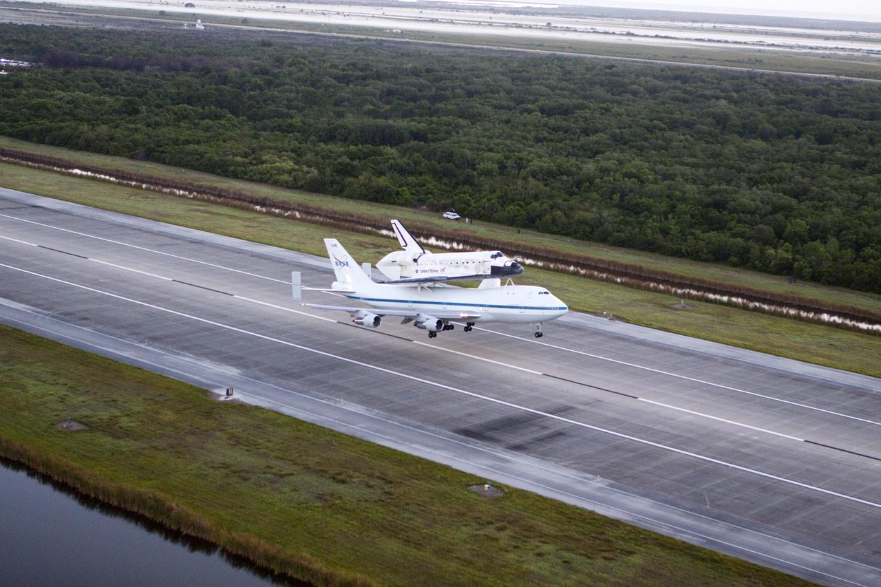 CAPE CANAVERAL, Fla. – In the early morning hours at NASA Kennedy Space Center’s Shuttle Landing Facility in Florida, the Shuttle Carrier Aircraft, or SCA, with space shuttle Discovery secured atop, takes off from runway 15 at 7 a.m. EDT. The SCA will deliver Discovery to its new home. The aircraft, known as an SCA, is a Boeing 747 jet, originally manufactured for commercial use, which was modified by NASA to transport the shuttles between destinations on Earth. This SCA, designated NASA 905, is assigned to the remaining ferry missions, delivering the shuttles to their permanent public display sites. NASA 905 is scheduled to ferry Discovery to the Washington Dulles International Airport in Virginia on April 17, after which the shuttle will be placed on display in the Smithsonian’s National Air and Space Museum, Steven F. Udvar-Hazy Center in Chantilly, Va. For more information on the SCA, visit http://www.nasa.gov/centers/dryden/news/FactSheets/FS-013-DFRC.html. For more information on shuttle transition and retirement activities, visit http://www.nasa.gov/transition. Photo credit: NASA/Glenn Benson
