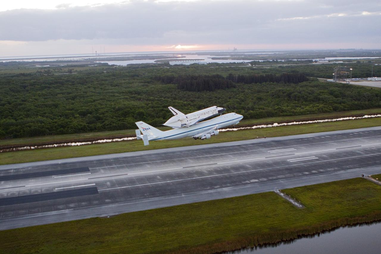 CAPE CANAVERAL, Fla. – In the early morning hours at NASA Kennedy Space Center’s Shuttle Landing Facility in Florida, the Shuttle Carrier Aircraft, or SCA, with space shuttle Discovery secured atop, takes off from runway 15 at 7 a.m. EDT. The SCA will deliver Discovery to its new home. The aircraft, known as an SCA, is a Boeing 747 jet, originally manufactured for commercial use, which was modified by NASA to transport the shuttles between destinations on Earth. This SCA, designated NASA 905, is assigned to the remaining ferry missions, delivering the shuttles to their permanent public display sites. NASA 905 is scheduled to ferry Discovery to the Washington Dulles International Airport in Virginia on April 17, after which the shuttle will be placed on display in the Smithsonian’s National Air and Space Museum, Steven F. Udvar-Hazy Center in Chantilly, Va. For more information on the SCA, visit http://www.nasa.gov/centers/dryden/news/FactSheets/FS-013-DFRC.html. For more information on shuttle transition and retirement activities, visit http://www.nasa.gov/transition. Photo credit: NASA/Glenn Benson