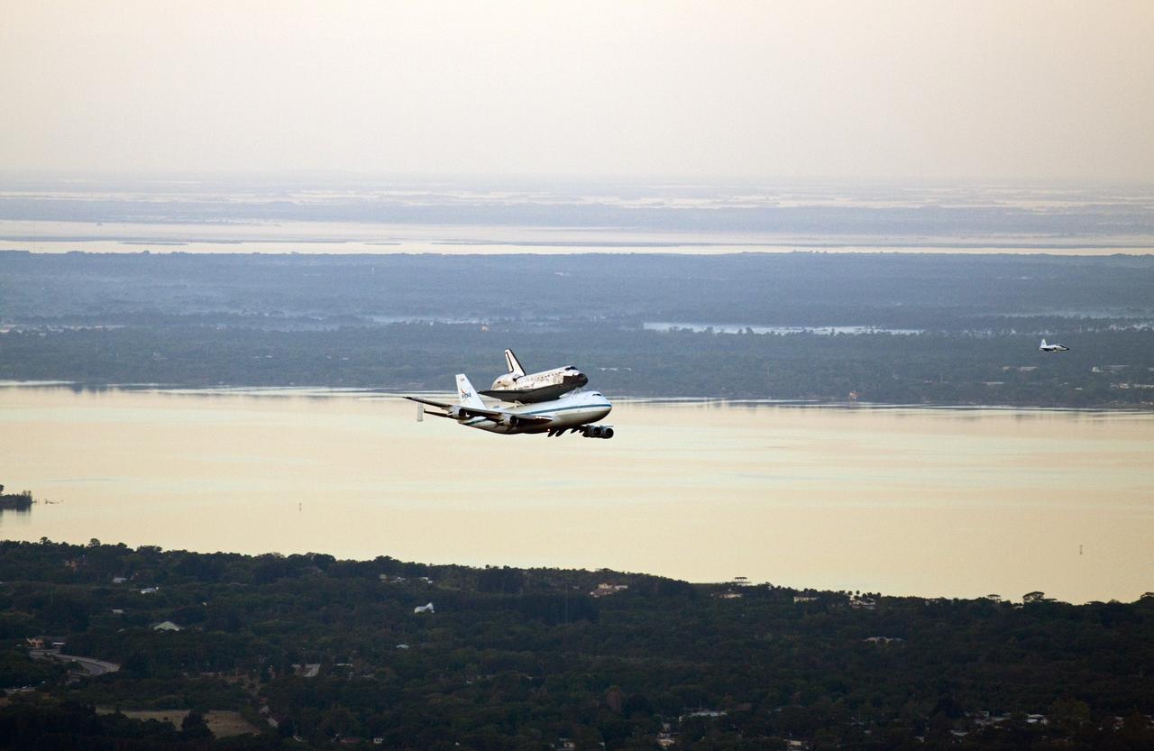 CAPE CANAVERAL, Fla. – The Shuttle Carrier Aircraft transporting space shuttle Discovery to its new home departs from NASA’s Kennedy Space Center in Florida at 7 a.m. EDT accompanied by a T-38 jet. The duo are heading south to fly over Brevard County’s beach communities for residents to get a look at the shuttle before it leaves the Space Coast for the last time. The aircraft, known as an SCA, is a Boeing 747 jet, originally manufactured for commercial use, which was modified by NASA to transport the shuttles between destinations on Earth. This SCA, designated NASA 905, is assigned to the remaining ferry missions, delivering the shuttles to their permanent public display sites. NASA 905 is scheduled to ferry Discovery to the Washington Dulles International Airport in Virginia today, after which the shuttle will be placed on display in the Smithsonian's National Air and Space Museum Steven F. Udvar-Hazy Center. For more information on the SCA, visit http://www.nasa.gov/centers/dryden/news/FactSheets/FS-013-DFRC.html. For more information on shuttle transition and retirement activities, visit http://www.nasa.gov/transition. Photo credit: NASA/Glenn Benson