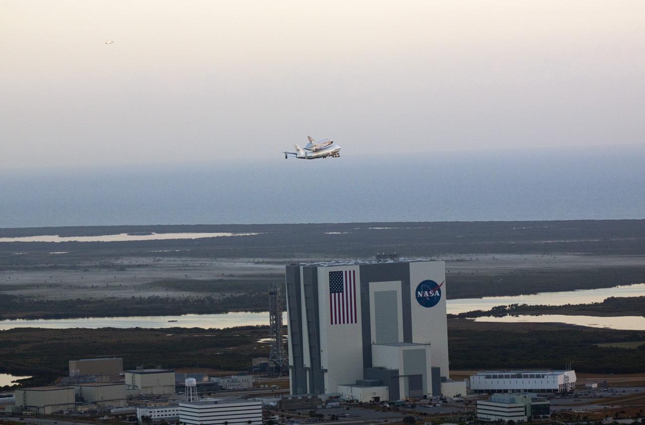 CAPE CANAVERAL, Fla. – The Shuttle Carrier Aircraft transporting space shuttle Discovery to its new home flies over the 525-foot-tall Vehicle Assembly Building at NASA’s Kennedy Space Center in Florida. The duo took off from Kennedy’s Shuttle Landing Facility at 7 a.m. EDT. The aircraft, known as an SCA, is a Boeing 747 jet, originally manufactured for commercial use, which was modified by NASA to transport the shuttles between destinations on Earth. This SCA, designated NASA 905, is assigned to the remaining ferry missions, delivering the shuttles to their permanent public display sites. NASA 905 is scheduled to ferry Discovery to the Washington Dulles International Airport in Virginia on April 17, after which the shuttle will be placed on display in the Smithsonian's National Air and Space Museum Steven F. Udvar-Hazy Center. For more information on the SCA, visit http://www.nasa.gov/centers/dryden/news/FactSheets/FS-013-DFRC.html. For more information on shuttle transition and retirement activities, visit http://www.nasa.gov/transition. Photo credit: NASA/Glenn Benson