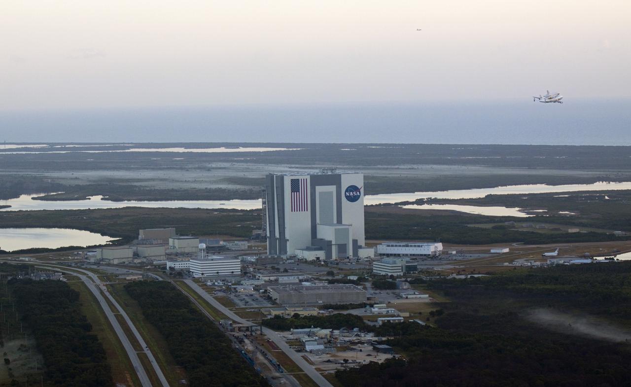 CAPE CANAVERAL, Fla. – The Shuttle Carrier Aircraft transporting space shuttle Discovery to its new home flies past the 525-foot-tall Vehicle Assembly Building at NASA’s Kennedy Space Center in Florida. The duo took off from Kennedy’s Shuttle Landing Facility at 7 a.m. EDT and are heading south to fly over Brevard County’s beach communities for residents to get a look at the shuttle before it leaves the Space Coast for the last time. The aircraft, known as an SCA, is a Boeing 747 jet, originally manufactured for commercial use, which was modified by NASA to transport the shuttles between destinations on Earth. This SCA, designated NASA 905, is assigned to the remaining ferry missions, delivering the shuttles to their permanent public display sites. NASA 905 is scheduled to ferry Discovery to the Washington Dulles International Airport in Virginia on April 17, after which the shuttle will be placed on display in the Smithsonian's National Air and Space Museum Steven F. Udvar-Hazy Center. For more information on the SCA, visit http://www.nasa.gov/centers/dryden/news/FactSheets/FS-013-DFRC.html. For more information on shuttle transition and retirement activities, visit http://www.nasa.gov/transition. Photo credit: NASA/Glenn Benson