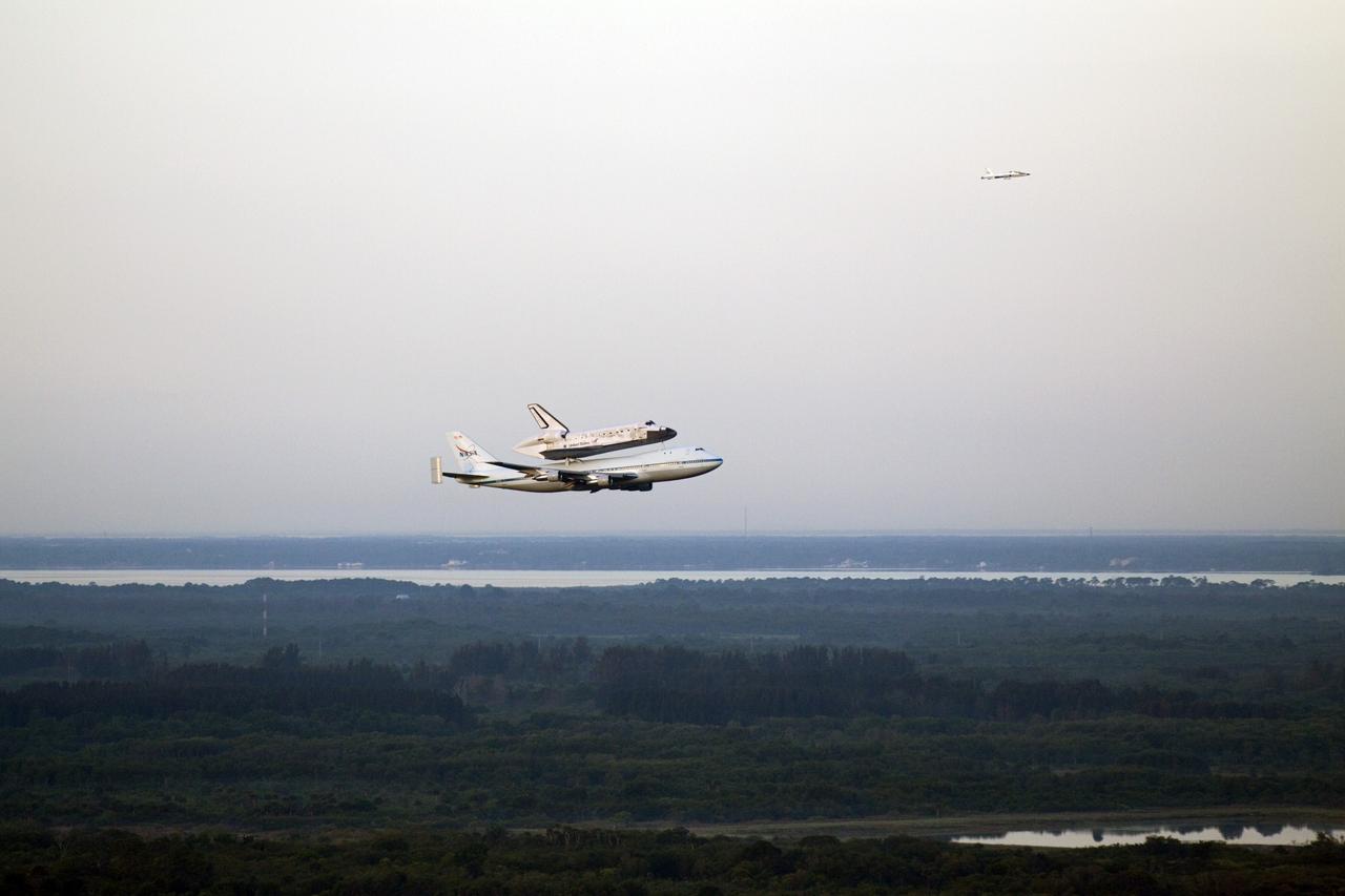 CAPE CANAVERAL, Fla. – The Shuttle Carrier Aircraft transporting space shuttle Discovery to its new home takes off from the Shuttle Landing Facility at NASA’s Kennedy Space Center in Florida at 7 a.m. EDT accompanied by a T-38 jet. The aircraft, known as an SCA, is a Boeing 747 jet, originally manufactured for commercial use, which was modified by NASA to transport the shuttles between destinations on Earth. This SCA, designated NASA 905, is assigned to the remaining ferry missions, delivering the shuttles to their permanent public display sites. NASA 905 is scheduled to ferry Discovery to the Washington Dulles International Airport in Virginia today, after which the shuttle will be placed on display in the Smithsonian's National Air and Space Museum Steven F. Udvar-Hazy Center. For more information on the SCA, visit http://www.nasa.gov/centers/dryden/news/FactSheets/FS-013-DFRC.html. For more information on shuttle transition and retirement activities, visit http://www.nasa.gov/transition. Photo credit: NASA/Glenn Benson