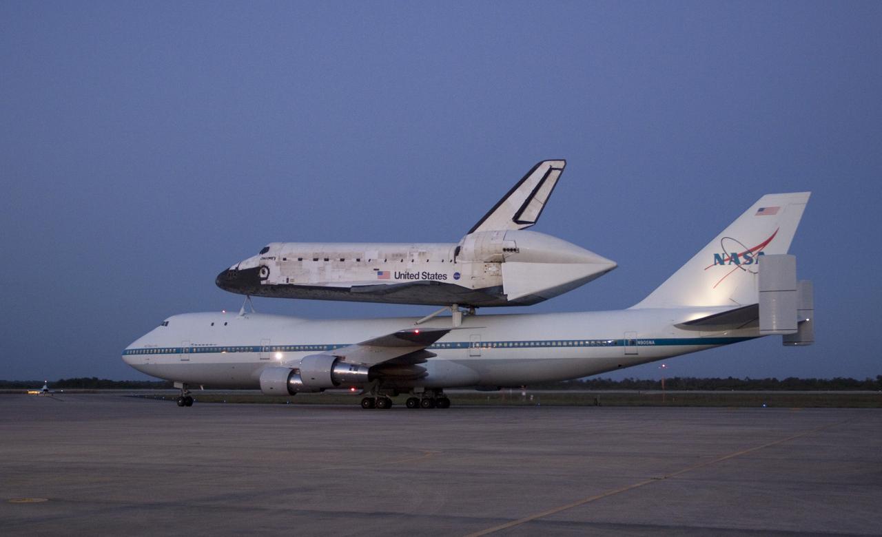 CAPE CANAVERAL, Fla. – Space shuttle Discovery, mounted to a Shuttle Carrier Aircraft, slowly rolls out to the runway of the Shuttle Landing Facility at NASA's Kennedy Space Center in Florida. The duo is set to begin their 3 1/2 hour ferry flight to the Washington Dulles International Airport in Virginia at about 7 a.m. EDT. Discovery is leaving Kennedy after more than 28 years of service beginning with its arrival on the space coast Nov. 9, 1983. Discovery first launched to space Aug. 30, 1984, on the STS-41D mission. Discovery is the agency's most-flown shuttle with 39 missions, more than 148 million miles and a total of one year in space. Discovery is set to move to the Smithsonian's National Air and Space Museum Steven F. Udvar-Hazy Center on April 19 where it will be placed on public display. For more information on the SCA, visit http://www.nasa.gov/centers/dryden/news/FactSheets/FS-013-DFRC.html. For more information on shuttle transition and retirement activities, visit http://www.nasa.gov/transition. Photo credit: NASA/Jim Grossmann