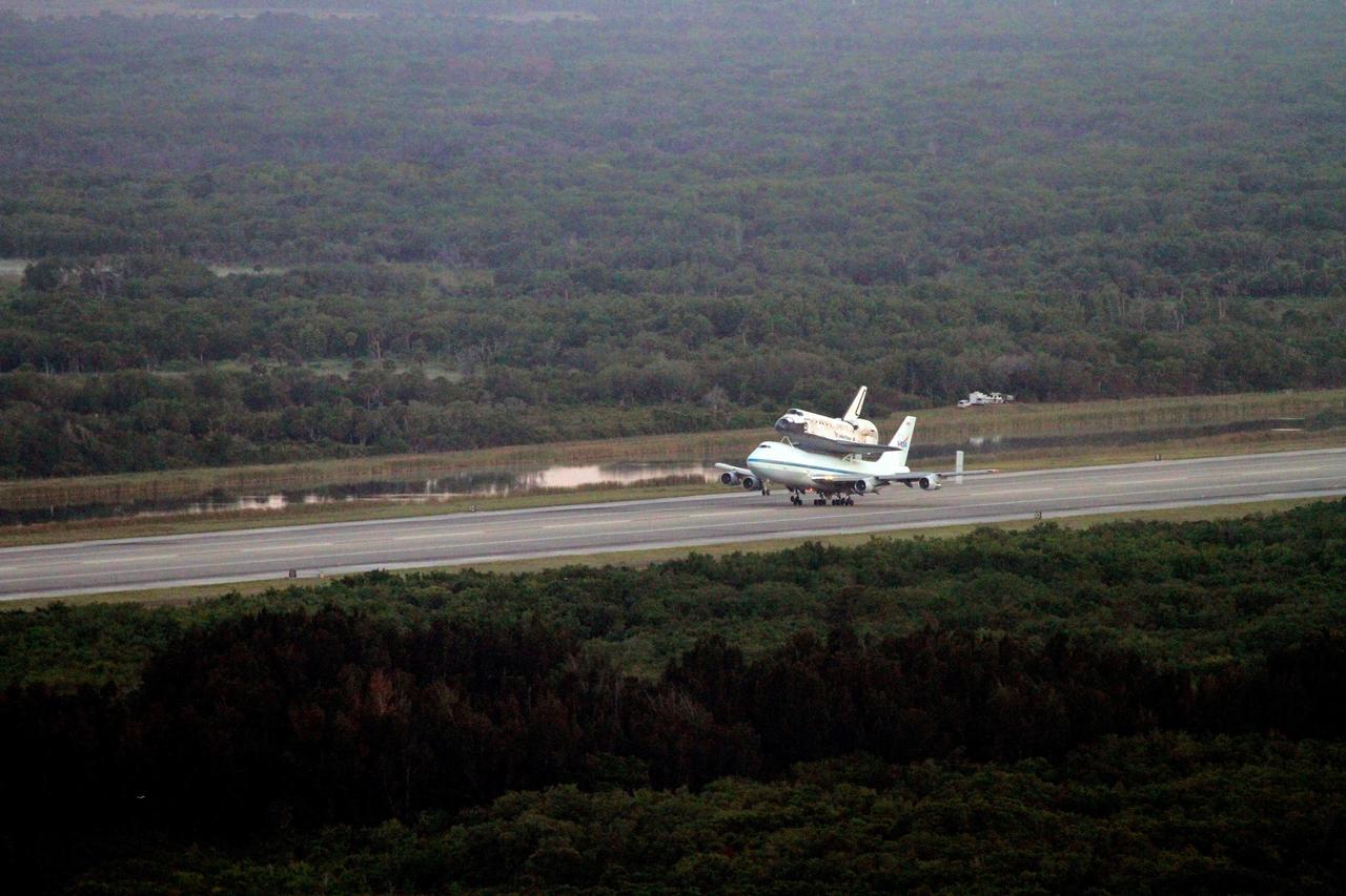 CAPE CANAVERAL, Fla. – The front wheel of the Shuttle Carrier Aircraft transporting space shuttle Discovery to its new home rises from the runway at the Shuttle Landing Facility at NASA’s Kennedy Space Center in Florida for a takeoff at 7 a.m. EDT. The aircraft, known as an SCA, is a Boeing 747 jet, originally manufactured for commercial use, which was modified by NASA to transport the shuttles between destinations on Earth. This SCA, designated NASA 905, is assigned to the remaining ferry missions, delivering the shuttles to their permanent public display sites. NASA 905 is scheduled to ferry Discovery to the Washington Dulles International Airport in Virginia on April 17, after which the shuttle will be placed on display in the Smithsonian's National Air and Space Museum Steven F. Udvar-Hazy Center. For more information on the SCA, visit http://www.nasa.gov/centers/dryden/news/FactSheets/FS-013-DFRC.html. For more information on shuttle transition and retirement activities, visit http://www.nasa.gov/transition. Photo credit: NASA/Lorne Mathre