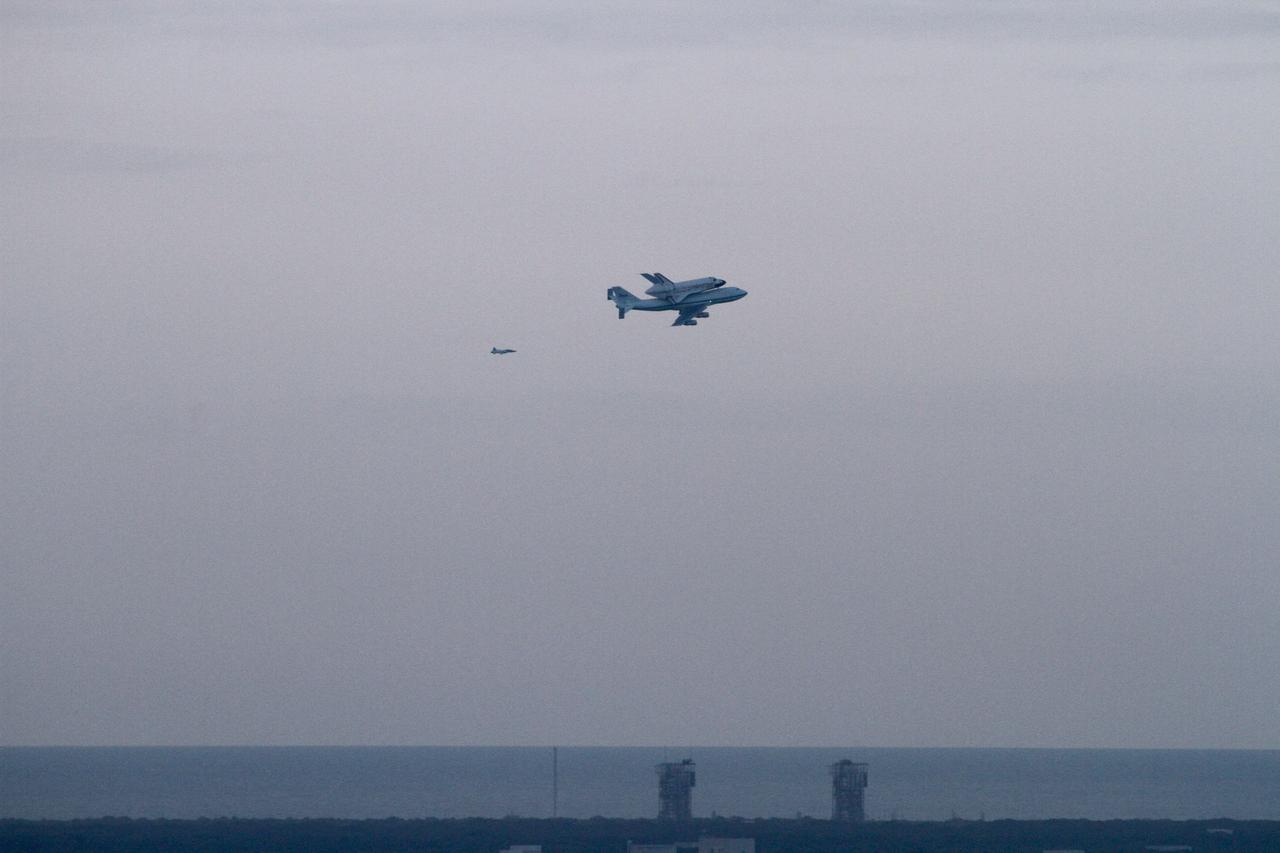 CAPE CANAVERAL, Fla. – The Shuttle Carrier Aircraft transporting space shuttle Discovery and its companion T-38 jet fly over Space Launch Complex-17 on Cape Canaveral Air Force Station after taking off from NASA Kennedy Space Center’s Shuttle Landing Facility at 7 a.m. EDT. The duo are heading south to fly over Brevard County’s beach communities, offering residents the opportunity to see the shuttle before it leaves the Space Coast for the last time.    The aircraft, known as an SCA, is a Boeing 747 jet, originally manufactured for commercial use, which was modified by NASA to transport the shuttles between destinations on Earth. This SCA, designated NASA 905, is assigned to the remaining ferry missions, delivering the shuttles to their permanent public display sites.  NASA 905 is scheduled to ferry Discovery to the Washington Dulles International Airport in Virginia on April 17, after which the shuttle will be placed on display in the Smithsonian's National Air and Space Museum Steven F. Udvar-Hazy Center. For more information on the SCA, visit http://www.nasa.gov/centers/dryden/news/FactSheets/FS-013-DFRC.html. For more information on shuttle transition and retirement activities, visit http://www.nasa.gov/transition. Photo credit: NASA/Lorne Mathre