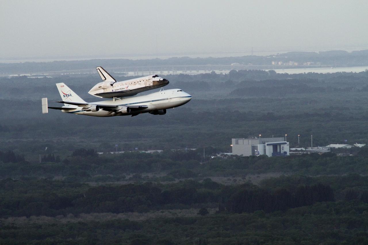 CAPE CANAVERAL, Fla. – The Shuttle Carrier Aircraft transporting space shuttle Discovery flies by the Shuttle Launch Experience at the Kennedy Space Center Visitor Complex following a pass over Brevard County’s beach communities, offering residents the opportunity to see the shuttle before it leaves the Space Coast for the last time. The duo took off from Kennedy’s Shuttle Landing Facility at 7 a.m. EDT. The aircraft, known as an SCA, is a Boeing 747 jet, originally manufactured for commercial use, which was modified by NASA to transport the shuttles between destinations on Earth. This SCA, designated NASA 905, is assigned to the remaining ferry missions, delivering the shuttles to their permanent public display sites. NASA 905 is scheduled to ferry Discovery to the Washington Dulles International Airport in Virginia on April 17, after which the shuttle will be placed on display in the Smithsonian's National Air and Space Museum Steven F. Udvar-Hazy Center. For more information on the SCA, visit http://www.nasa.gov/centers/dryden/news/FactSheets/FS-013-DFRC.html. For more information on shuttle transition and retirement activities, visit http://www.nasa.gov/transition. Photo credit: NASA/Lorne Mathre