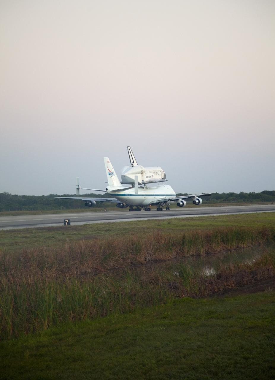 CAPE CANAVERAL, Fla. – Space shuttle Discovery, mounted to a Shuttle Carrier Aircraft, prepares for takeoff on the runway of the Shuttle Landing Facility at NASA's Kennedy Space Center in Florida. The duo is set to begin their 3 1/2 hour ferry flight to the Washington Dulles International Airport in Virginia at about 7 a.m. EDT. Above the two craft is a NASA helicopter covering the departure. Discovery is leaving Kennedy after more than 28 years of service beginning with its arrival on the space coast Nov. 9, 1983. Discovery first launched to space Aug. 30, 1984, on the STS-41D mission. Discovery is the agency's most-flown shuttle with 39 missions, more than 148 million miles and a total of one year in space. Discovery is set to move to the Smithsonian's National Air and Space Museum Steven F. Udvar-Hazy Center on April 19 where it will be placed on public display. For more information on the SCA, visit http://www.nasa.gov/centers/dryden/news/FactSheets/FS-013-DFRC.html. For more information on shuttle transition and retirement activities, visit http://www.nasa.gov/transition. Photo credit: NASA/Frankie Martin