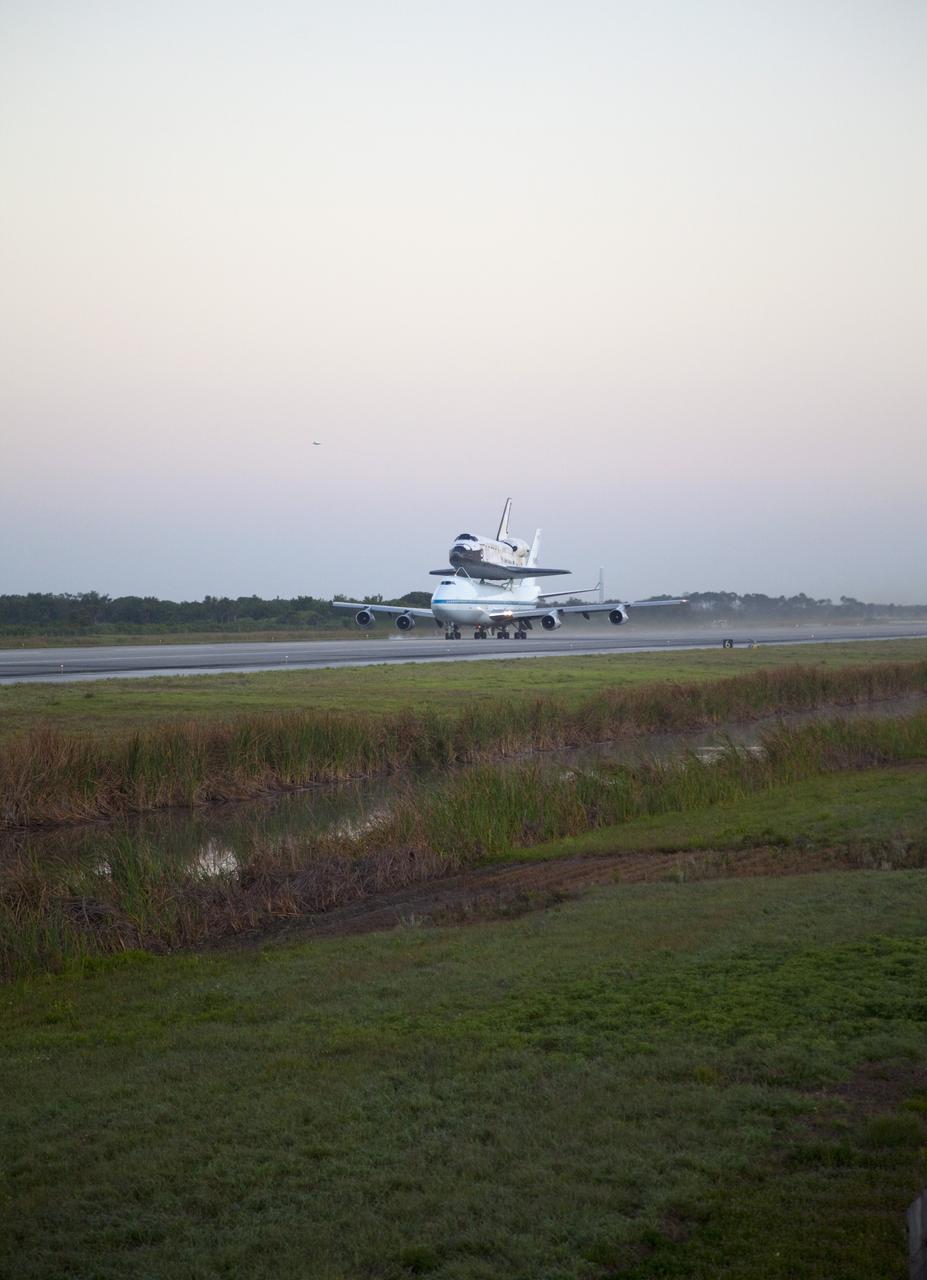CAPE CANAVERAL, Fla. – Space shuttle Discovery, mounted to a Shuttle Carrier Aircraft, prepares for takeoff on the runway of the Shuttle Landing Facility at NASA's Kennedy Space Center in Florida. The duo is set to begin their 3 1/2 hour ferry flight to the Washington Dulles International Airport in Virginia at about 7 a.m. EDT. Above the two craft is a NASA helicopter covering the departure. Discovery is leaving Kennedy after more than 28 years of service beginning with its arrival on the space coast Nov. 9, 1983. Discovery first launched to space Aug. 30, 1984, on the STS-41D mission. Discovery is the agency's most-flown shuttle with 39 missions, more than 148 million miles and a total of one year in space. Discovery is set to move to the Smithsonian's National Air and Space Museum Steven F. Udvar-Hazy Center on April 19 where it will be placed on public display. For more information on the SCA, visit http://www.nasa.gov/centers/dryden/news/FactSheets/FS-013-DFRC.html. For more information on shuttle transition and retirement activities, visit http://www.nasa.gov/transition. Photo credit: NASA/Frankie Martin