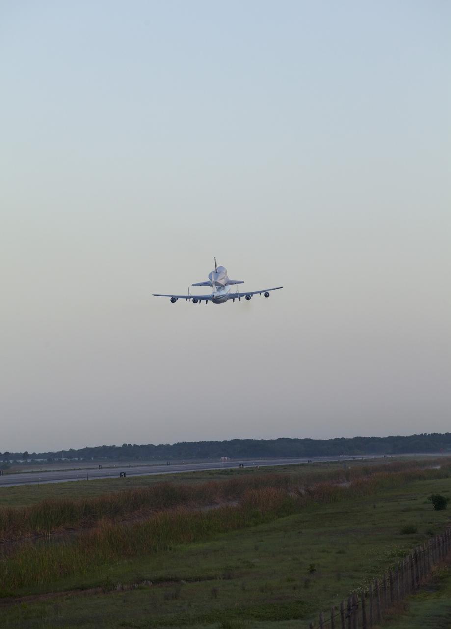 CAPE CANAVERAL, Fla. – Space shuttle Discovery, mounted to a Shuttle Carrier Aircraft, soars over the Shuttle Landing Facility at NASA's Kennedy Space Center in Florida. The duo is beginning their 3 1/2 hour ferry flight to the Washington Dulles International Airport in Virginia. Also flying along with the pair is a T-38 training jet. Discovery is leaving Kennedy after more than 28 years of service beginning with its arrival on the space coast Nov. 9, 1983. Discovery first launched to space Aug. 30, 1984, on the STS-41D mission. Discovery is the agency's most-flown shuttle with 39 missions, more than 148 million miles and a total of one year in space. Discovery is set to move to the Smithsonian's National Air and Space Museum Steven F. Udvar-Hazy Center on April 19 where it will be placed on public display. For more information on the SCA, visit http://www.nasa.gov/centers/dryden/news/FactSheets/FS-013-DFRC.html. For more information on shuttle transition and retirement activities, visit http://www.nasa.gov/transition. Photo credit: NASA/Frankie Martin