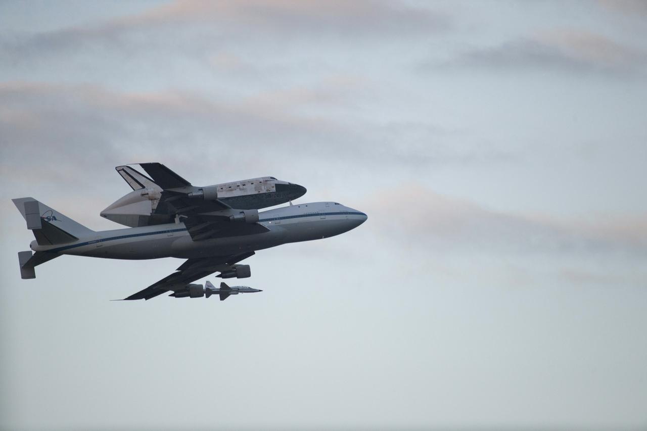CAPE CANAVERAL, Fla. – Space shuttle Discovery, mounted to a Shuttle Carrier Aircraft, flies over the Shuttle Landing Facility at NASA's Kennedy Space Center in Florida after making a flyby of Cocoa Beach and Patrick Air Force Base. The duo is beginning its ferry flight to the Washington Dulles International Airport in Virginia that also includes a flyby of the Space Coast and Washington, D.C. Also flying along with the pair is a T-38 training jet. Discovery is leaving Kennedy after more than 28 years of service beginning with its arrival on the space coast Nov. 9, 1983. Discovery first launched to space Aug. 30, 1984, on the STS-41D mission. Discovery is the agency's most-flown shuttle with 39 missions, more than 148 million miles and a total of one year in space.       Discovery is set to move to the Smithsonian's National Air and Space Museum Steven F. Udvar-Hazy Center on April 19 where it will be placed on public display. For more information on the SCA, visit http://www.nasa.gov/centers/dryden/news/FactSheets/FS-013-DFRC.html. For more information on shuttle transition and retirement activities, visit http://www.nasa.gov/transition. Photo credit: NASA/Kenny Allen