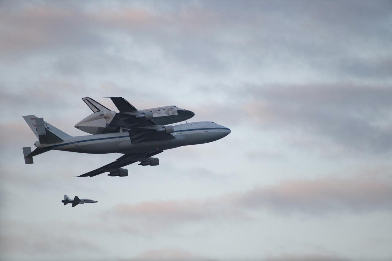 CAPE CANAVERAL, Fla. – Space shuttle Discovery, mounted to a Shuttle Carrier Aircraft, flies over the Shuttle Landing Facility at NASA's Kennedy Space Center in Florida after making a flyby of Cocoa Beach and Patrick Air Force Base. The duo is beginning its ferry flight to the Washington Dulles International Airport in Virginia that also includes a flyby of the Space Coast and Washington, D.C. Also flying along with the pair is a T-38 training jet. Discovery is leaving Kennedy after more than 28 years of service beginning with its arrival on the space coast Nov. 9, 1983. Discovery first launched to space Aug. 30, 1984, on the STS-41D mission. Discovery is the agency's most-flown shuttle with 39 missions, more than 148 million miles and a total of one year in space.   Discovery is set to move to the Smithsonian's National Air and Space Museum Steven F. Udvar-Hazy Center on April 19 where it will be placed on public display. For more information on the SCA, visit http://www.nasa.gov/centers/dryden/news/FactSheets/FS-013-DFRC.html. For more information on shuttle transition and retirement activities, visit http://www.nasa.gov/transition. Photo credit: NASA/Kenny Allen